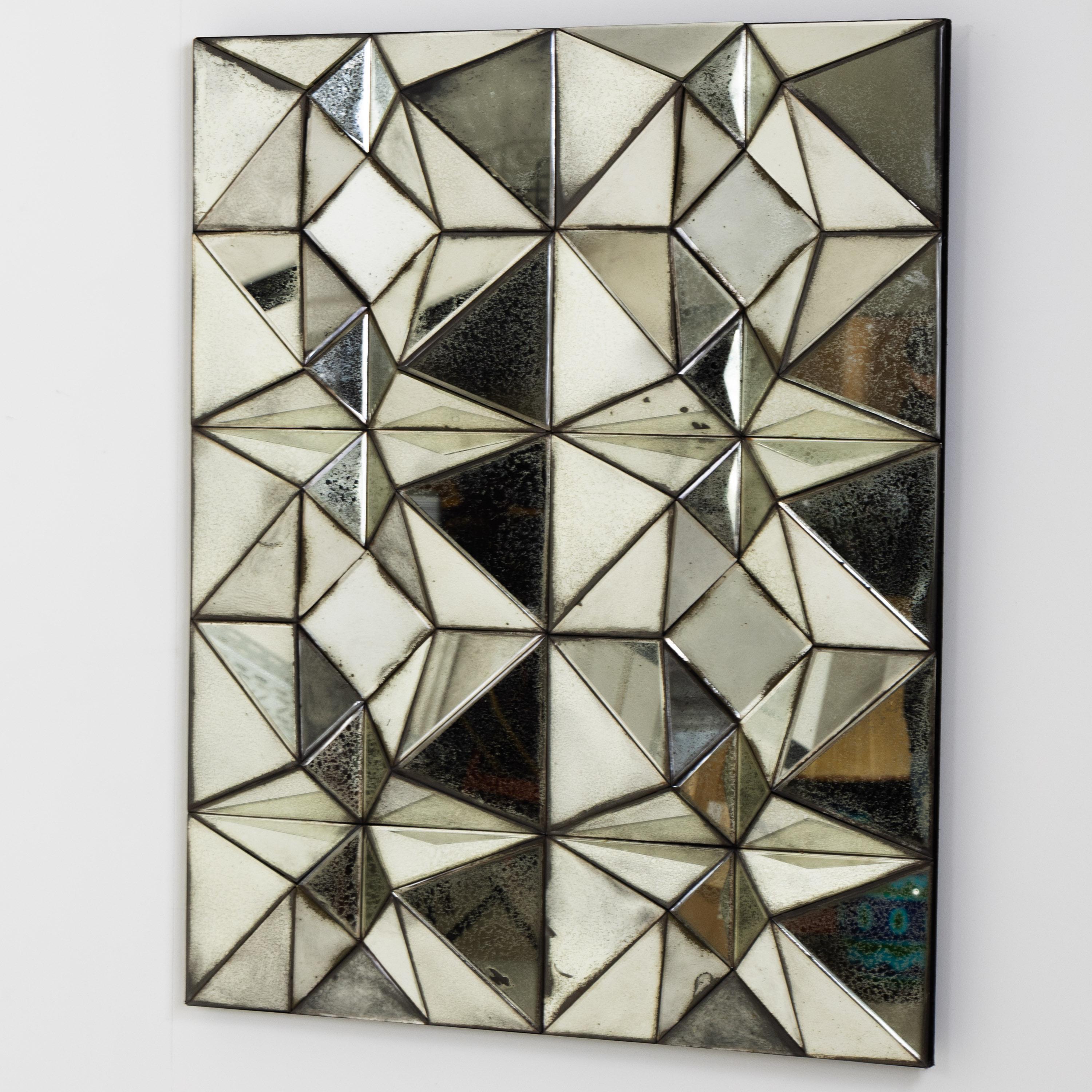 Mirror from the Ode's Design series with triangular or square discs, which are arranged into pyramids, creating a concave-convex mirror surface. Inscribed, signed and numbered on the reverse.