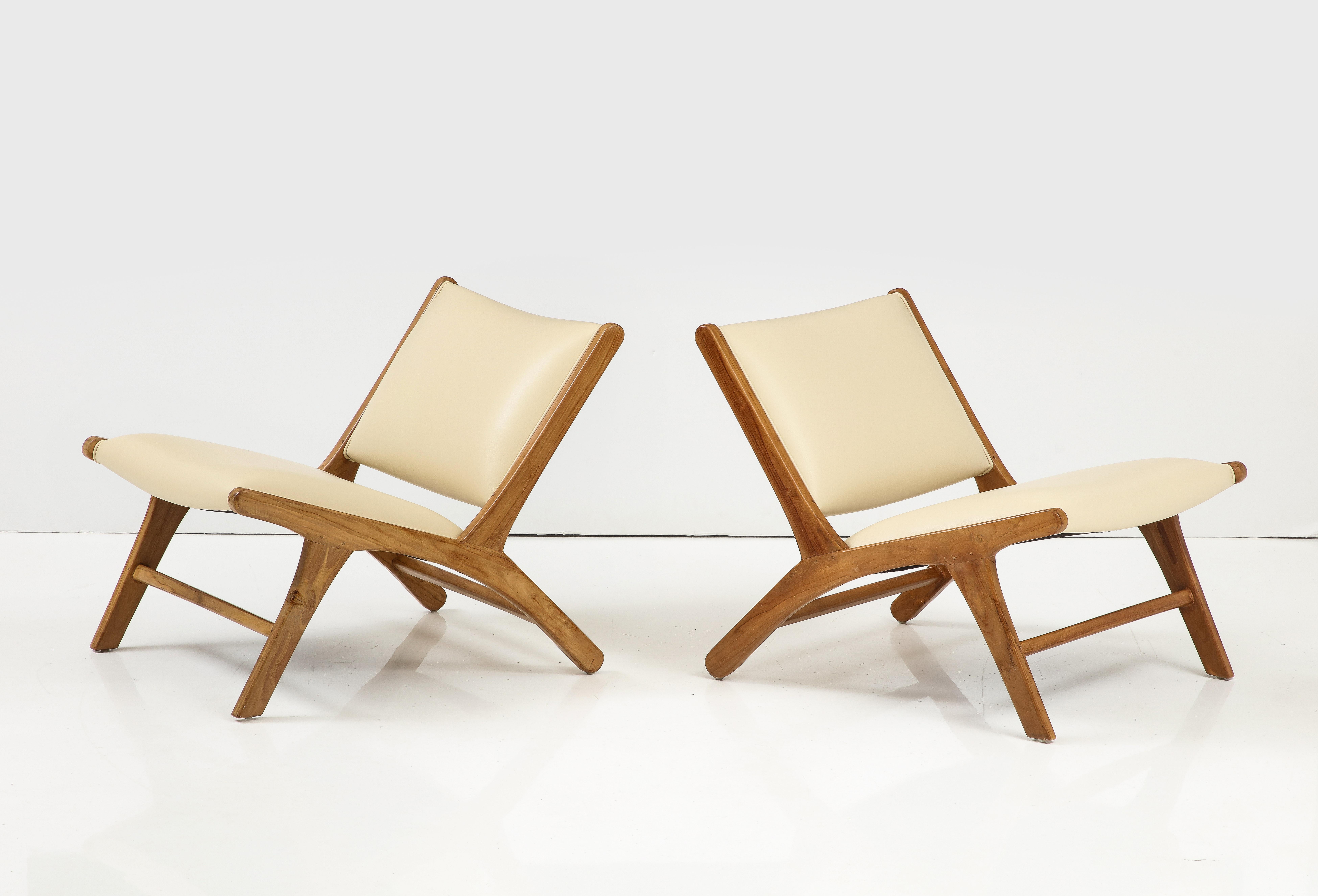 A striking and sleek pair of lounge chairs designed by Olivier De Schrijver, the Belgian contemporary artist, who was born in 1958. Newly re-finished and re-upholstered in a butter colored Italian leather. 
By Olivier De Schrijver, signed and