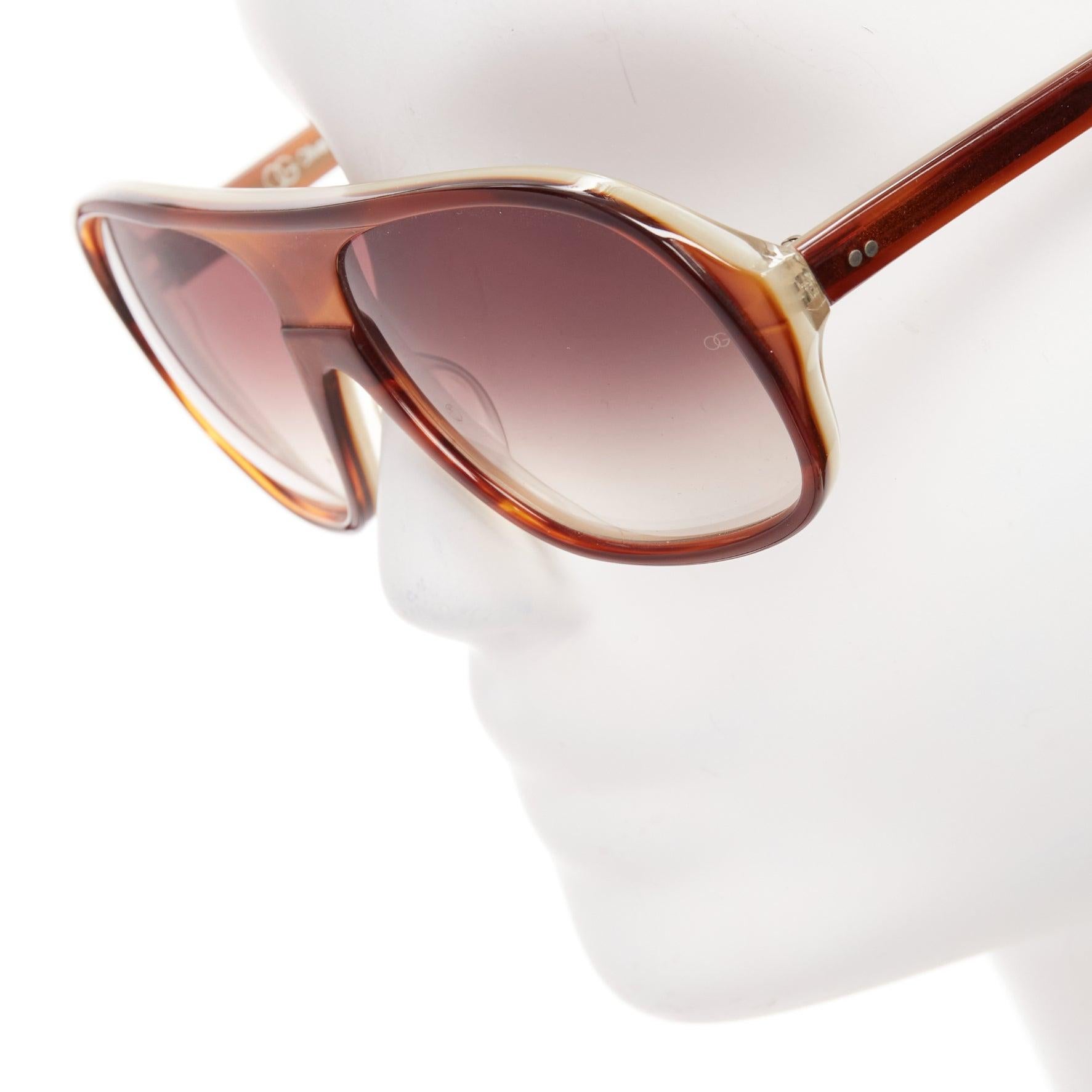 OLIVIER GOLDSMITH Carl dark butterscotch brown aviator sunglasses
Reference: AAWC/A01010
Brand: Olivier Goldsmith
Model: Carl
Material: Acetate
Color: Brown
Pattern: Solid
Lining: Brown Acetate
Extra Details: Side studsand OG logo on