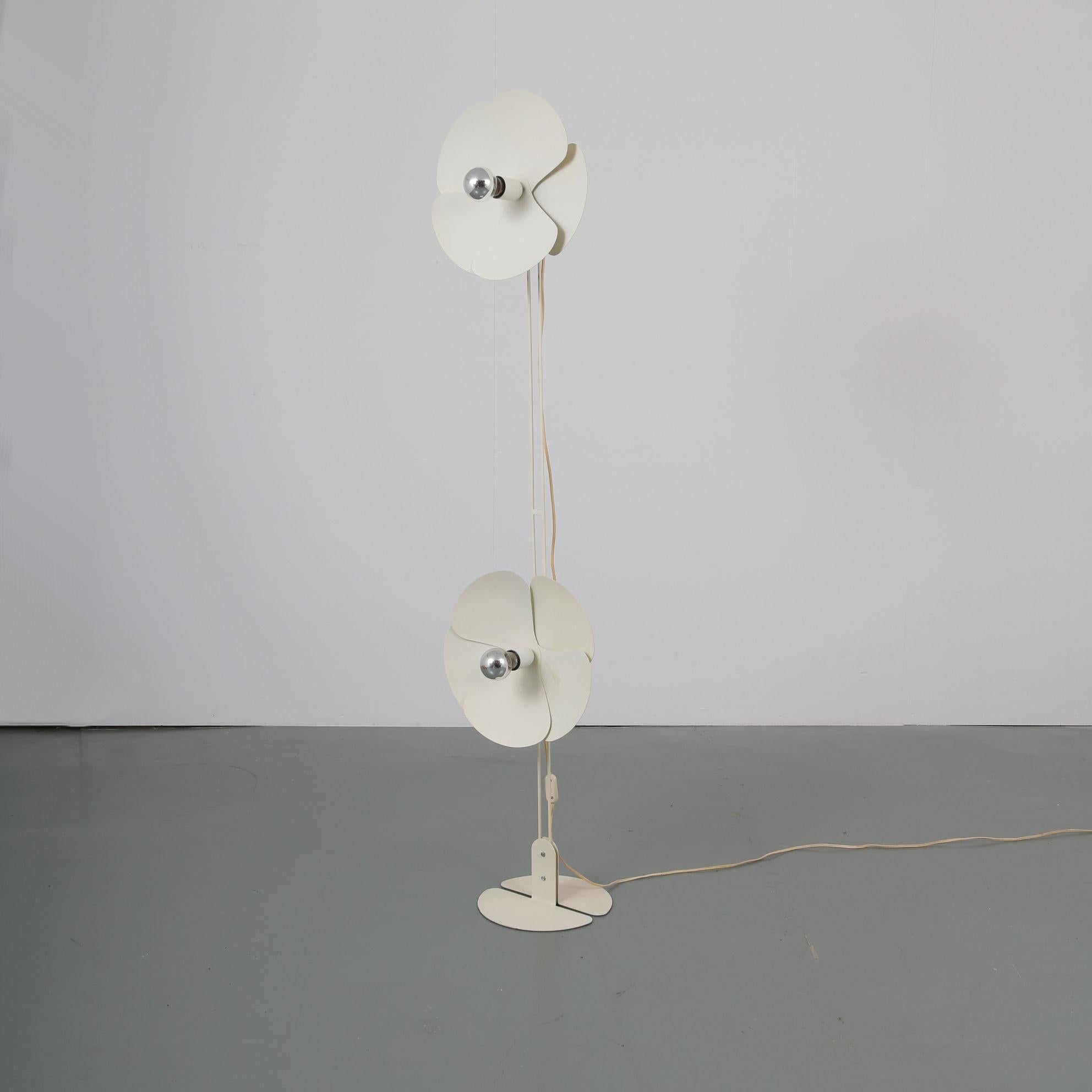 An elegant floor lamp designed by Olivier Morgue, manufactured and labeled by Disderot in France, circa 1960.

The eye-catching feature of this rare piece are the two shades that have a beautiful layered flower pattern. They give the lamp a