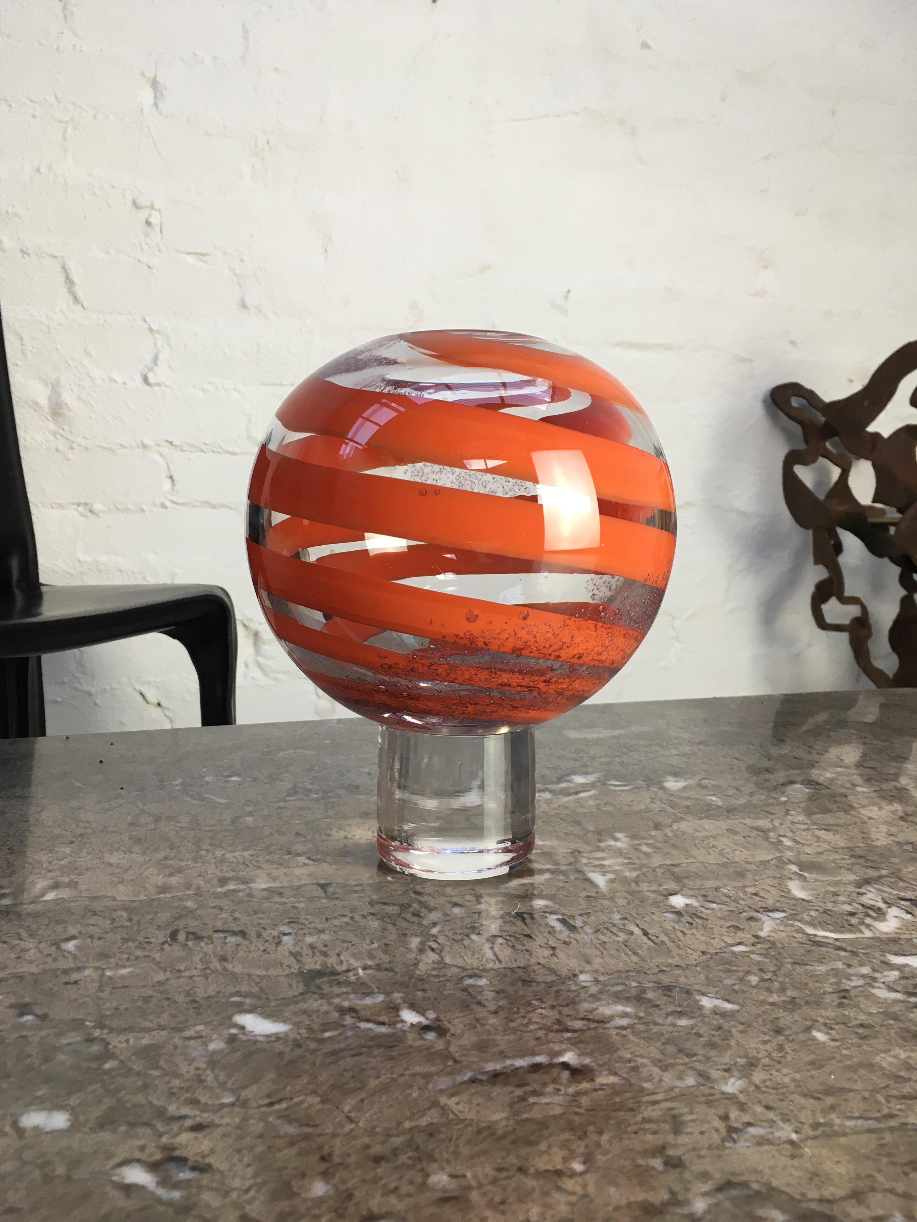 An Orrefors Art Glass crystal vase, signed ‘Orrefors Expo 231-72 Olle Alberius’ (Olle Alberius, 1972). 

Colour and shape combine to give this vase a punchy Op Art effect. Inside the thick spherical walls, metalic bubbles swirl up in one direction