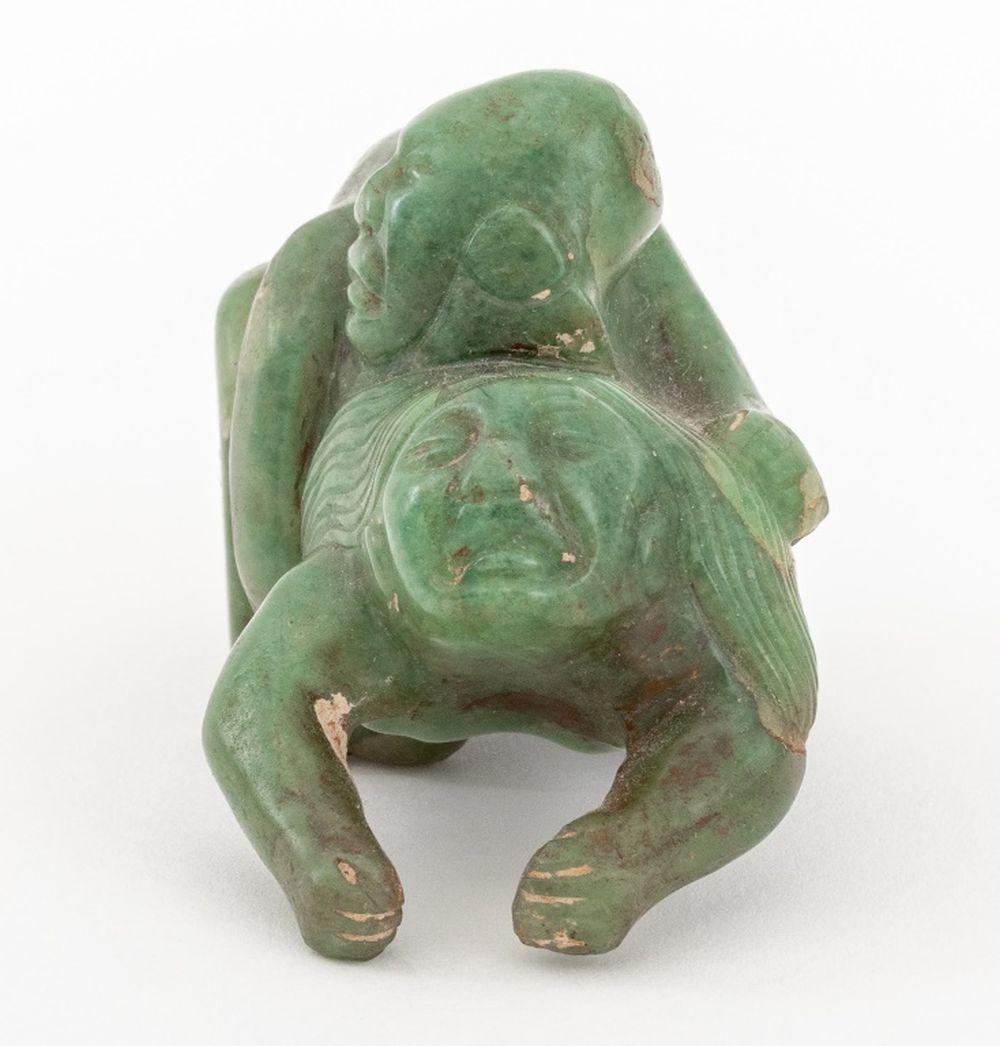 Olmec Pre-Columbian Carved Jade Erotic Sculpture, depicting a male figure embracing a female figure. 1.75