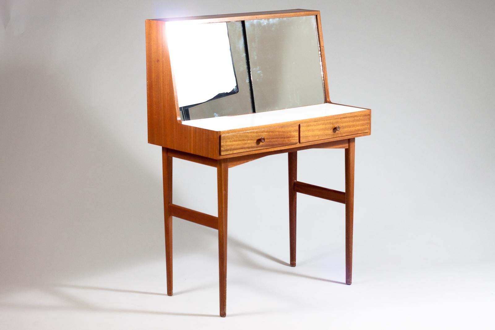 Stylish Mid-Century Modern vanity desk with two drawers made in mahogany. Two sliding mirrors covering two glass shelves for storing make-up and other necessary things.