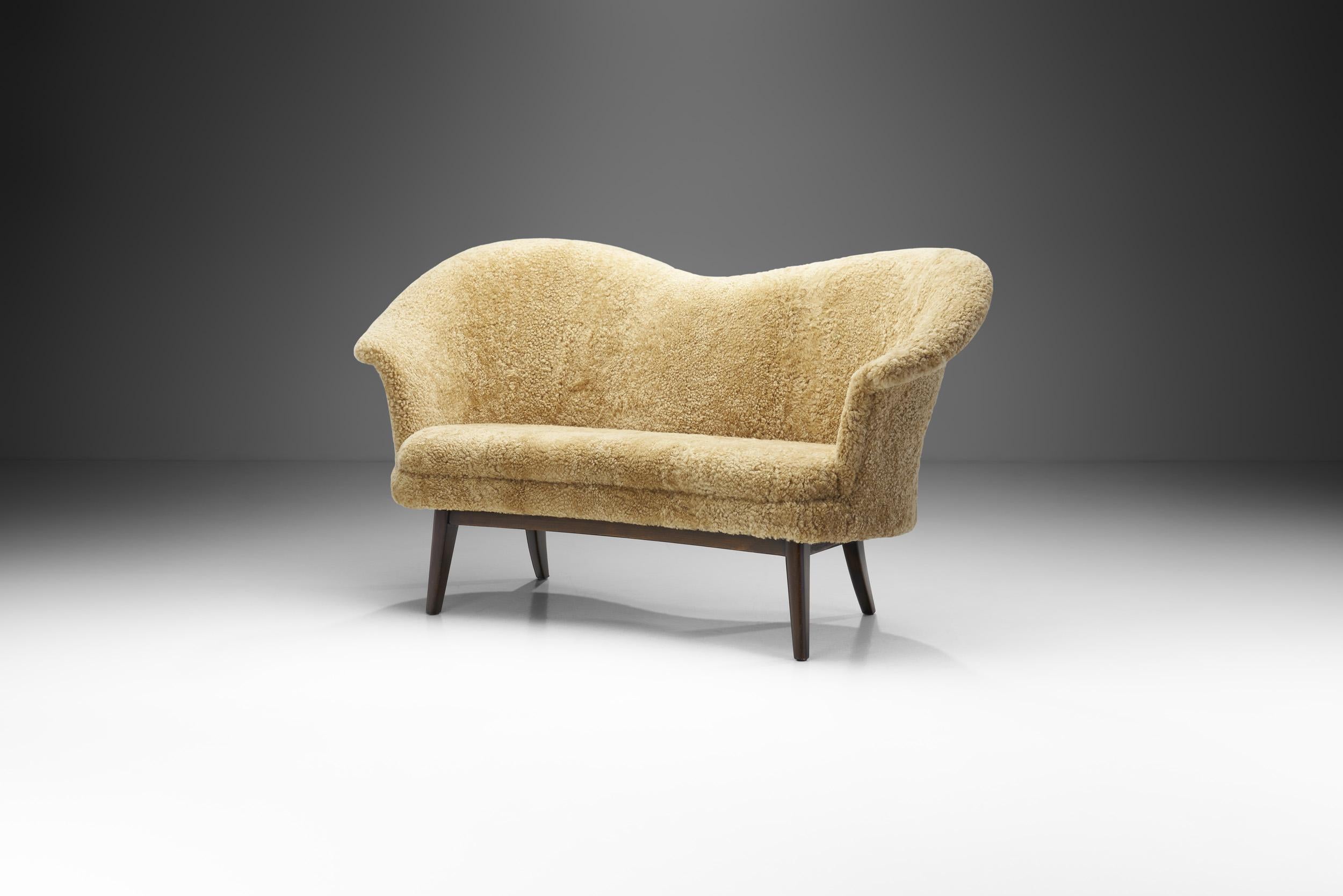 This lovely “Duetto” loveseat was designed back in the 1950s to bring the sitters closer together. This intention is clearly traceable in Ottelin’s drawings, where the back was drawn as hands embracing the users.

A loveseat derives its name from
