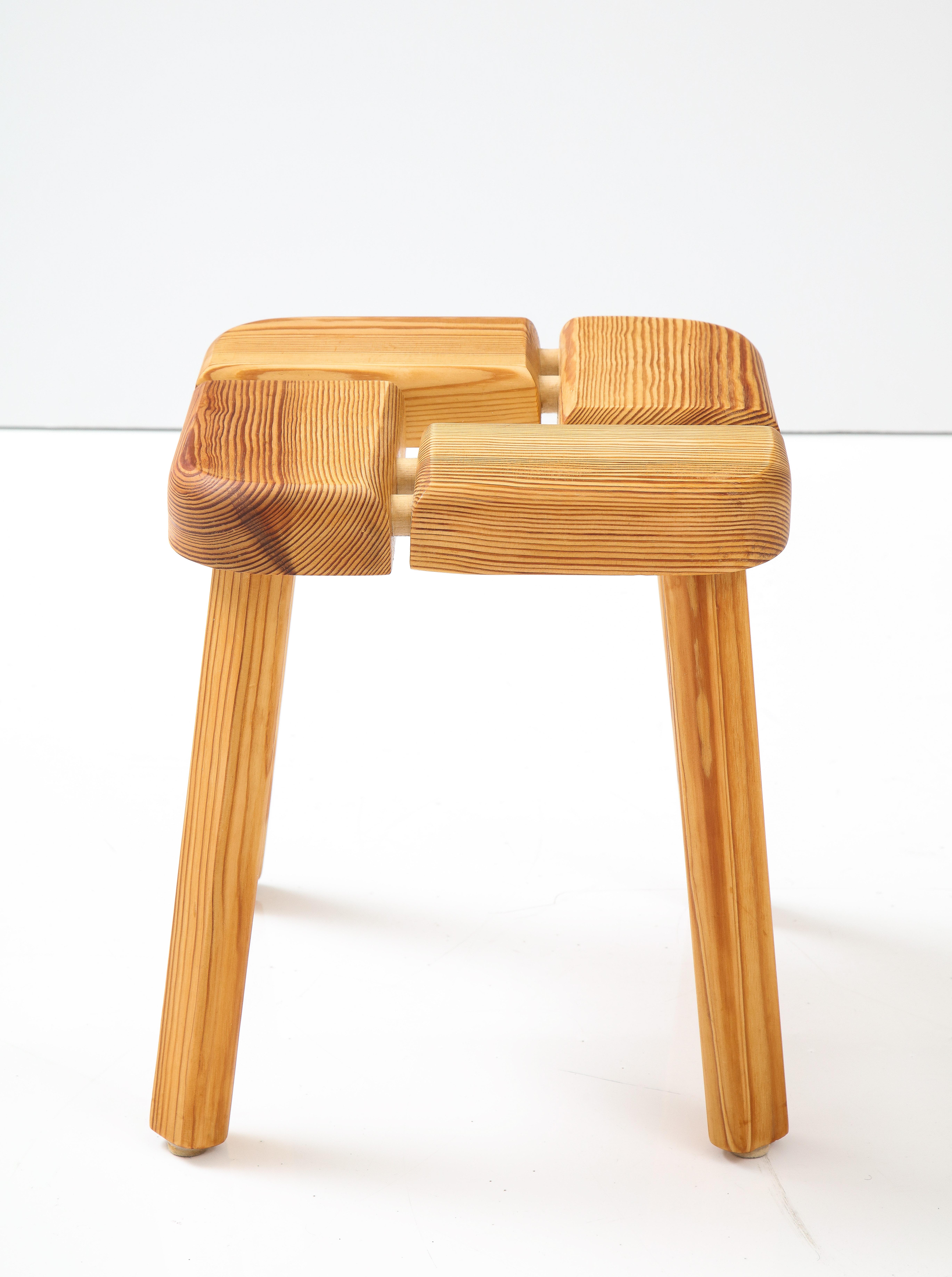 A Finnish pine Modernist stool, Circa 1970s, by Olof Ottelin, the top with four rectangular blocks joined by extended dowels raised on straight legs.