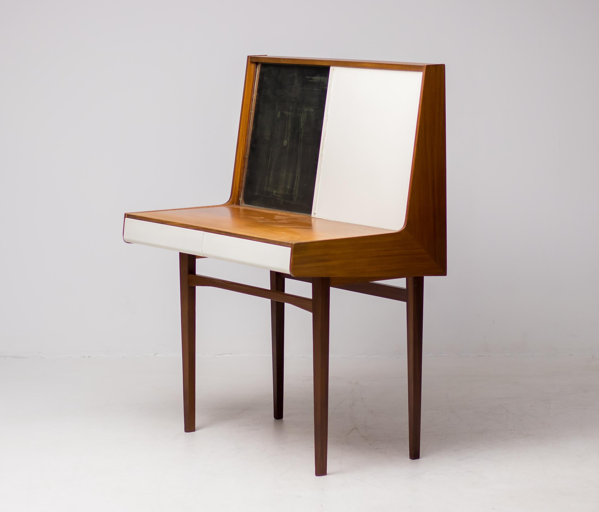 Elegant dressing table designed circa 1950 by Olof Ottelin for Stockmann Oy, Finland.
The mirror is worn from age, we will replace it with a contemporary mirror at no extra charge upon request.
Base in teak, drawer fronts and sliding door in