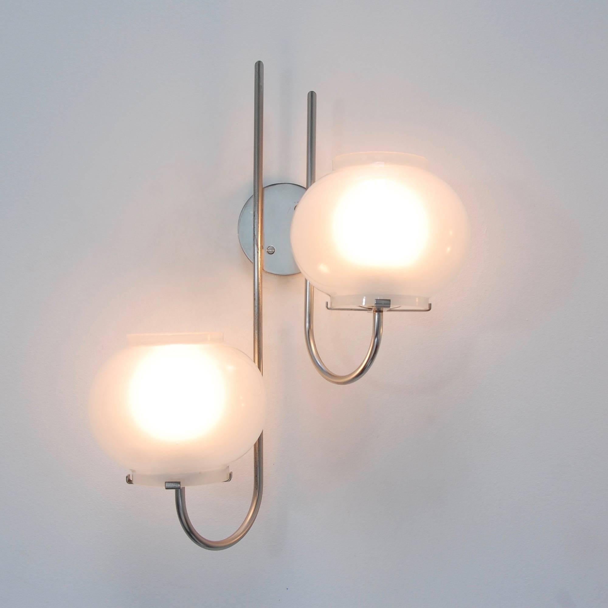 Classic pair of Oluce Italian 1960s double shade wall sconces by Tito Agnoli. Nickel plated brass and blown patinated glass. Partially restored. Currently wired for use in the US. Light bulbs and all mounting hardware supplied with order. Measure: