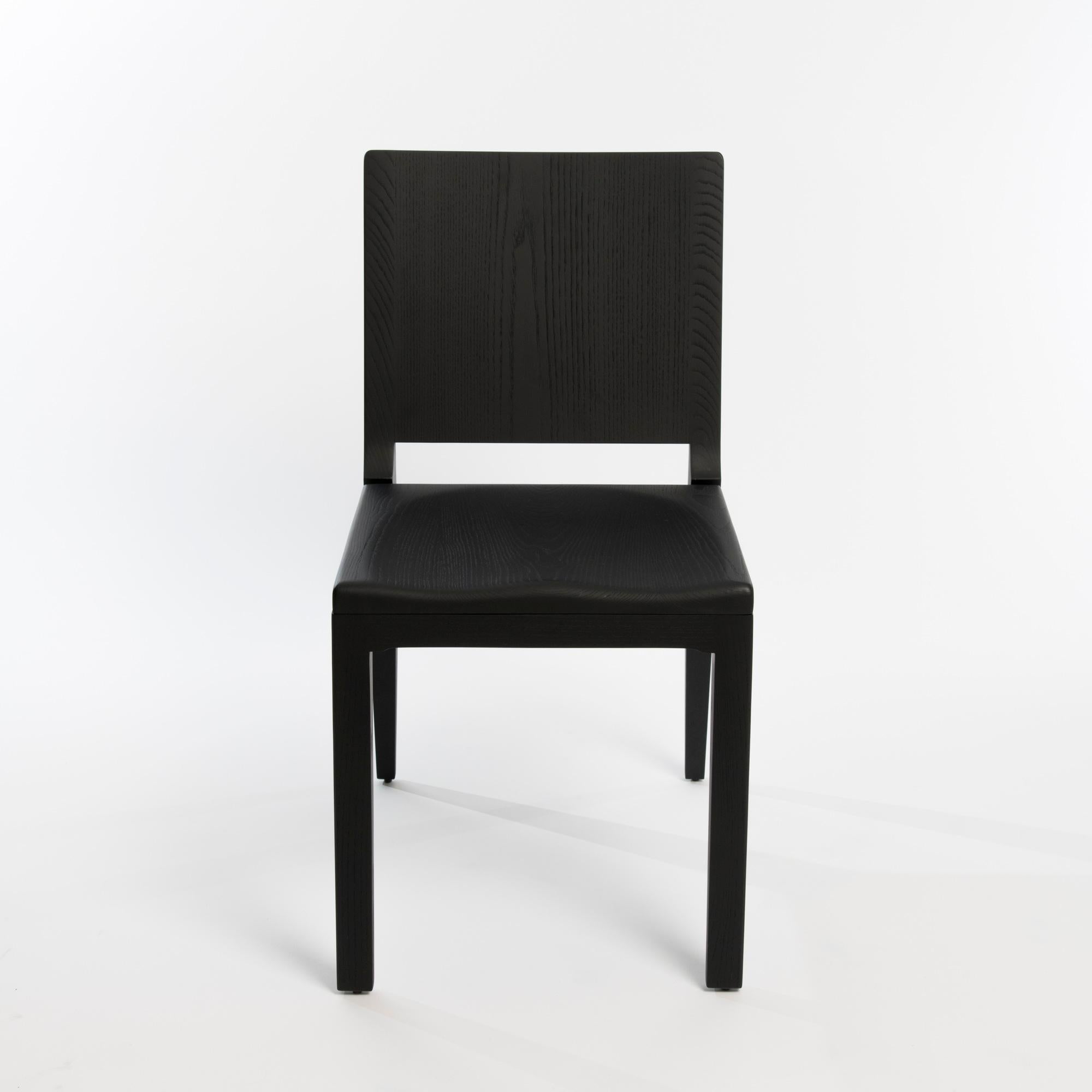 Minimal design chair by Parisian based studio mjiila. The om5.0 is a contemporary high-end chair handcrafted by skilled cabinetmaker. The curved ergonomic solid wood seat is accurately made on a CNC. Available in natural or black stained ash, matte