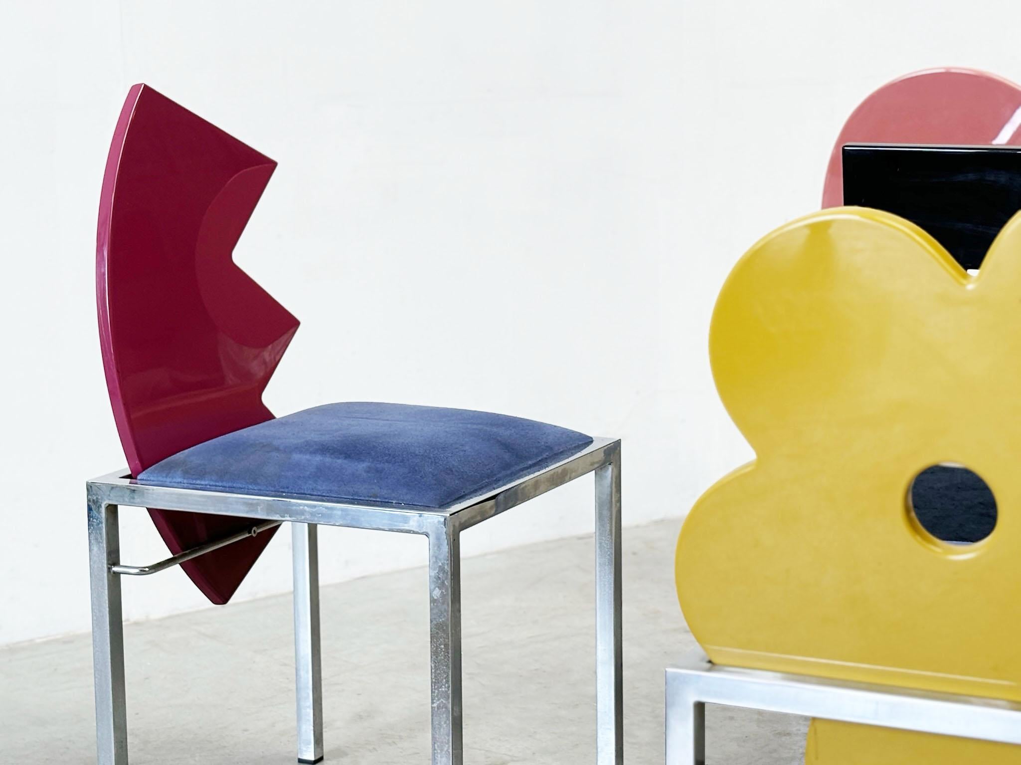 Unique and striking dining chairs designed by Salvati & Tresoldi for Saporiti Italia.

The chairs feature chrome frames with blue velvet seats and lacquered wooden figure backrests.

The playful design make them very attractive, as well as the