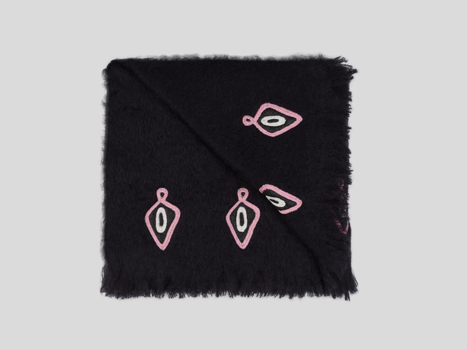 Omaka, a graphic black blanket made of the finest New Zealand mohair. This throw is embellished with pink and cream embroidery done by hand. Nothing as personal as your own interior, the colors of the fabric and embroidery can be customized on