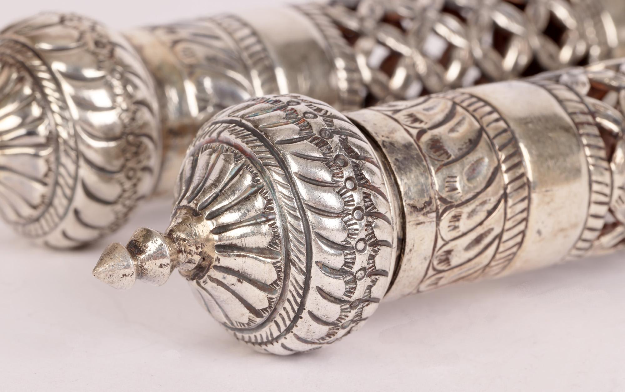 A fine pair vintage Omani silver pierced scroll or document holders believed to date to the early to mid 20th century. The scroll holders are of long hollow cylindrical shape with decorative finials to either end, one doubling up as a removable cap