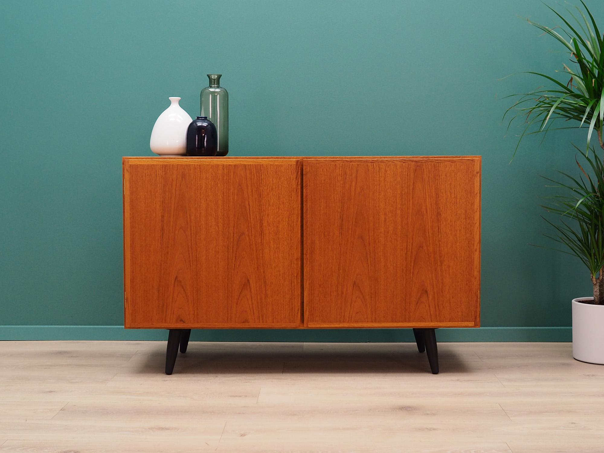 Fantastic cabinet from the 1960s-1970s. Scandinavian design, Minimalist form. Manufactured by Omann Junn. Surface of the furniture finished with teak veneer. Three shelves and two drawers in the interior. Furniture is kept in good condition (minor