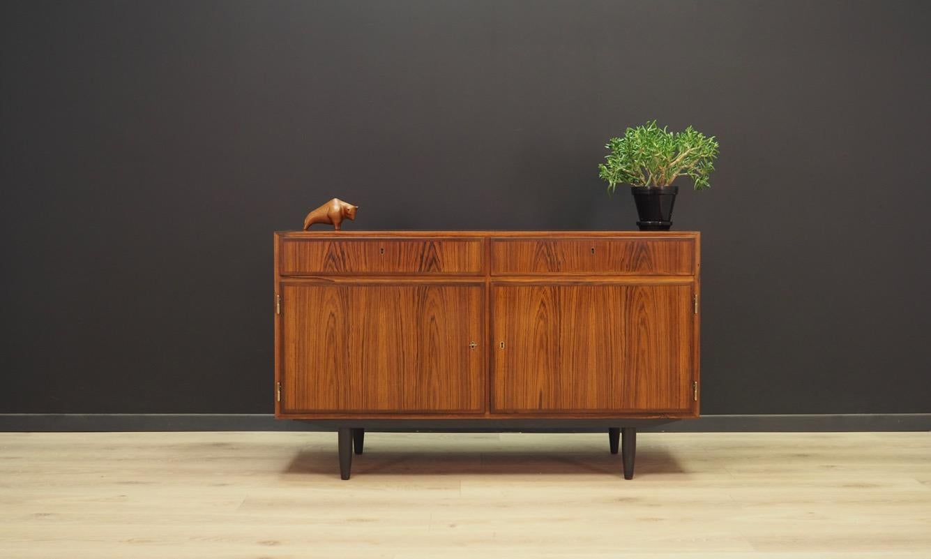 Fantastic cabinet from the 1960s-1970s. Danish design, minimalistic form. Manufactured by Omann Jun. Surface covered with rosewood veneer. The furniture has two drawers and two shelves in the interior. Maintained in good condition (minor bruises and