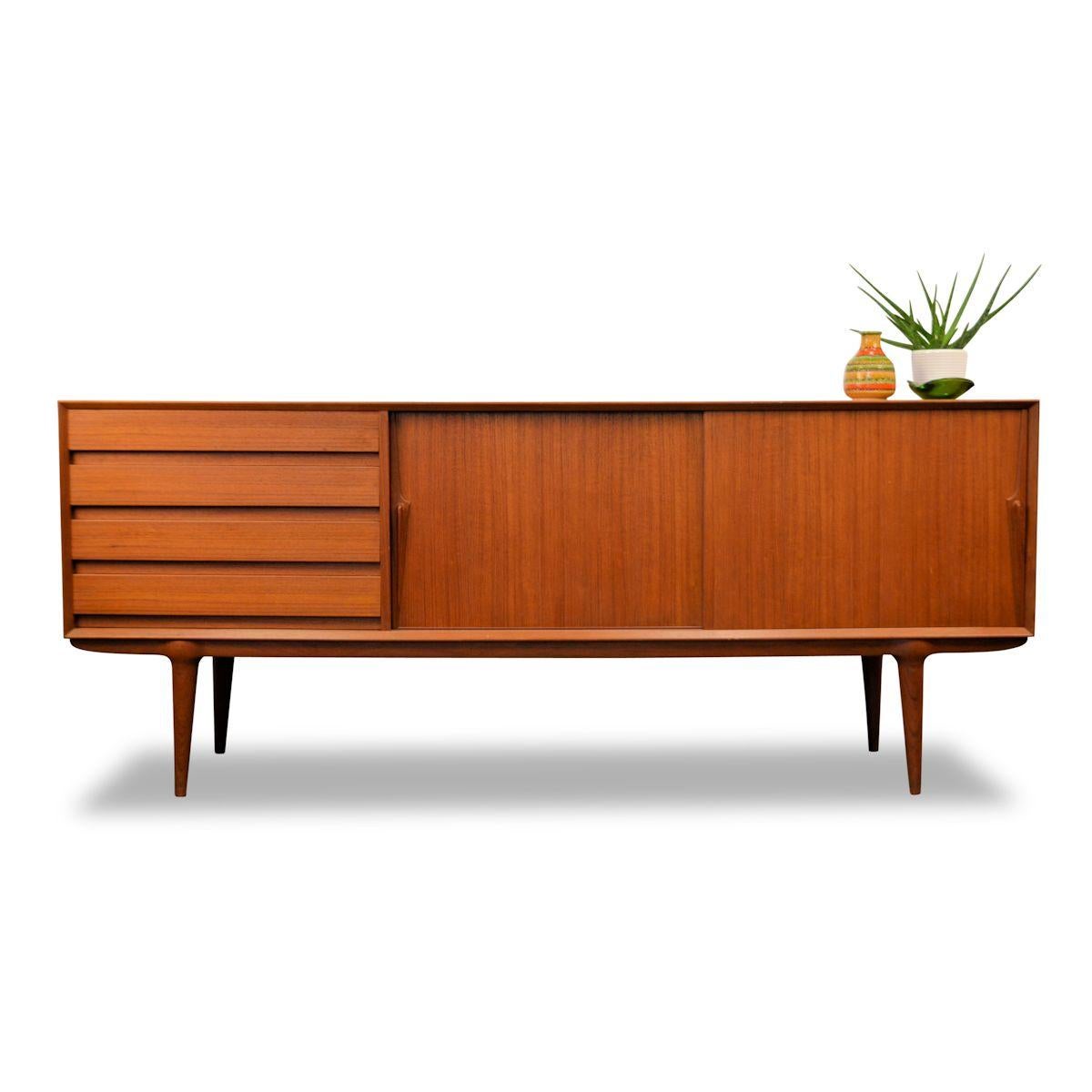 Danish modern teak model 18 sideboard designed by Gunni Omann for Omann Jun Møbelfabrik. This family owned business is still very much alive today and is headed by the third generation of Omanns. Many of the company’s designs were designed by family