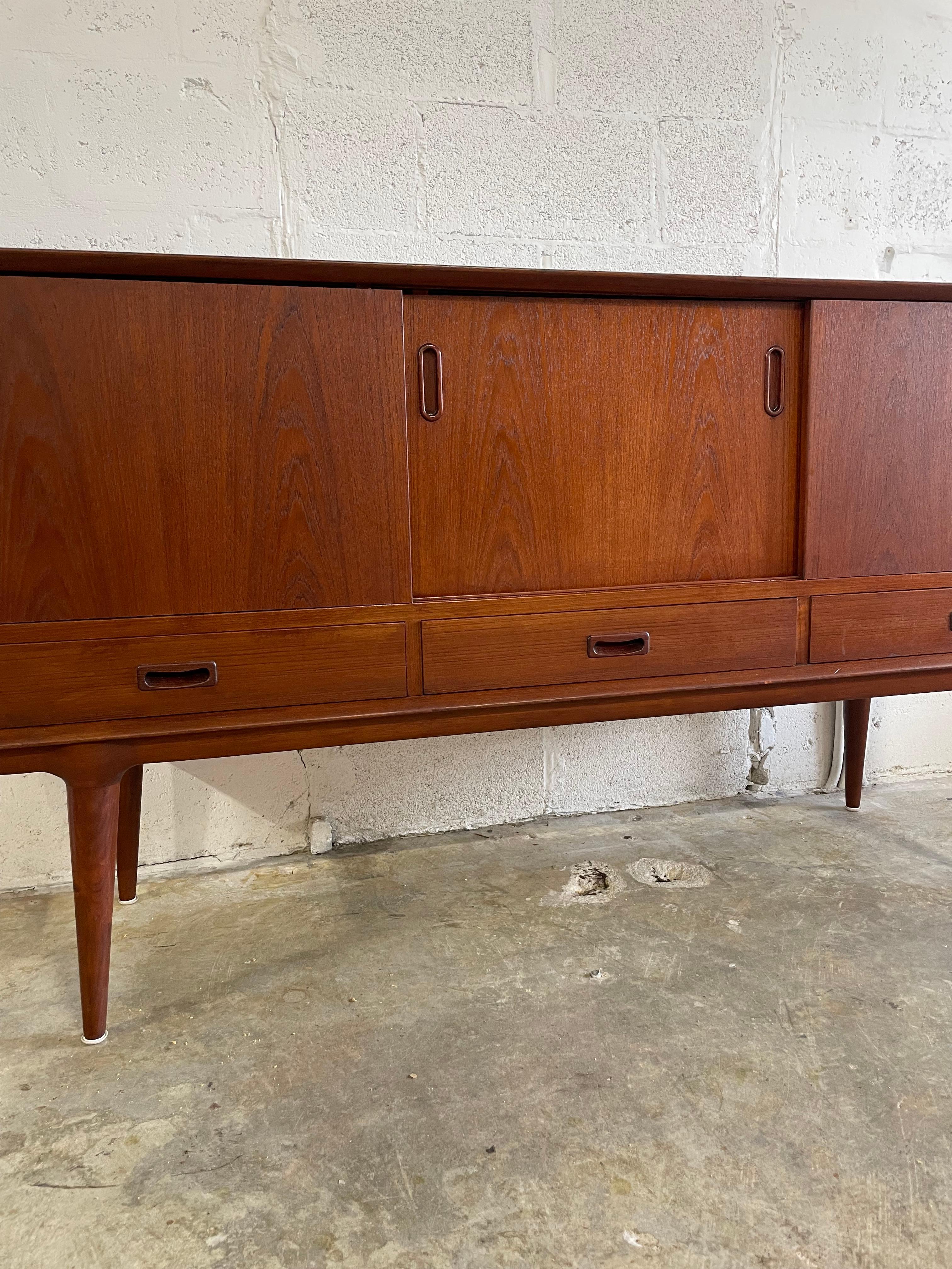 Consolle o credenza moderna danese di Oman Junn. Scaffale a sinistra e cassetti sottili a destra. Gambe scultoree e dentellate. 
