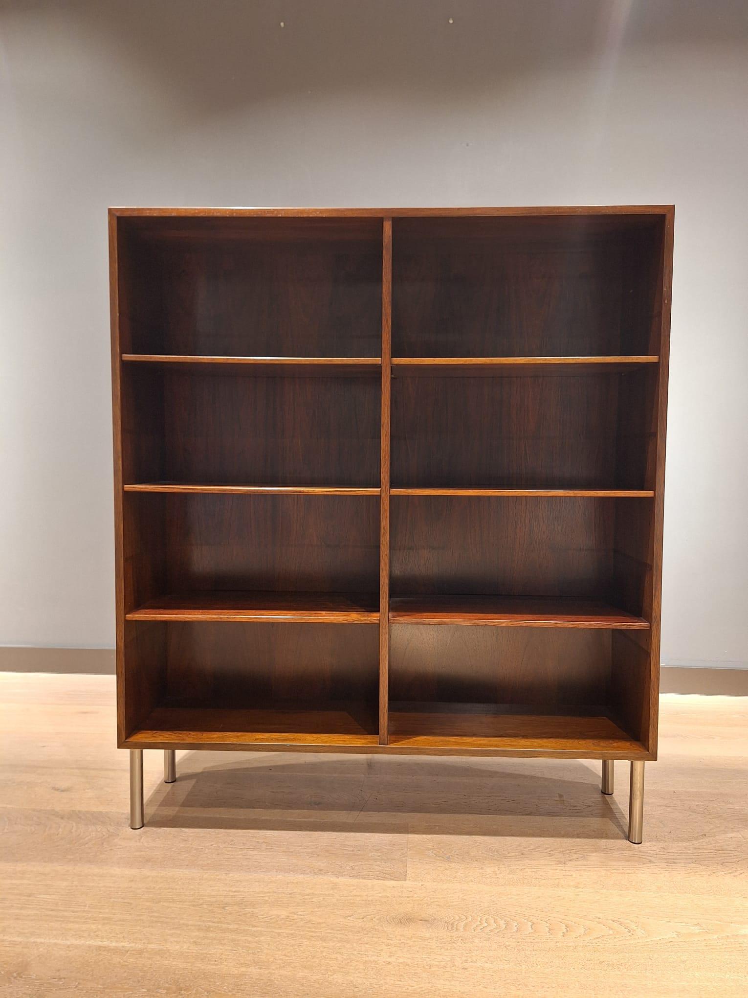Danish book case manufactured by Omann Jun Mobelfabrik in the 1960s.  The bookcase is made with vibrant and rich rosewood. It has six individual shelves, all of which can be adjusted and moved as required. The manufacturer's label Omann Jun is on