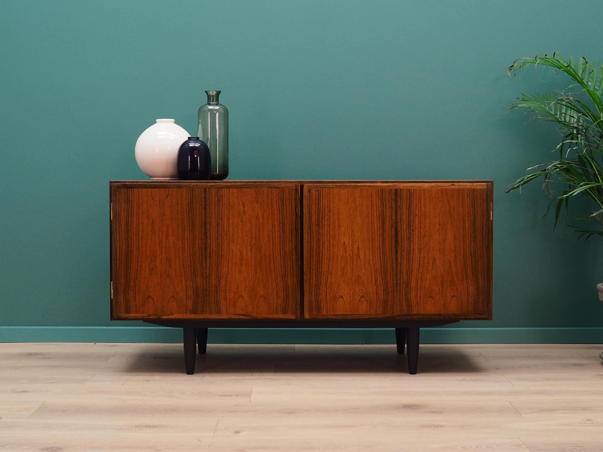 Fantastic cabinet from the 1960s-1970s. Scandinavian design, Minimalist form. Model #1 manufactured by Omann Jun. Surface of the furniture finished with rosewood veneer. Shelf and drawer in the interior. Preserved in good condition (minor bruises