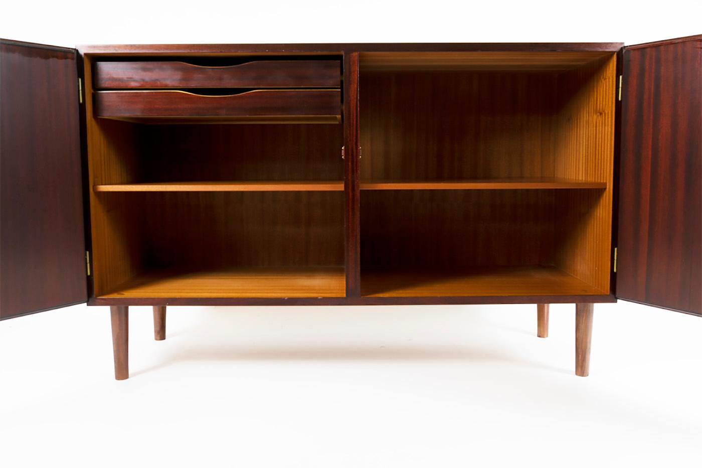 Rosewood cabinet from the 1960s-1970s, Danish design. Manufactured by Omann Jun. Furniture surface finished with rosewood veneer. Inside there are two drawers covered with green fabric for cutlery and adjustable shelves. Doors with 