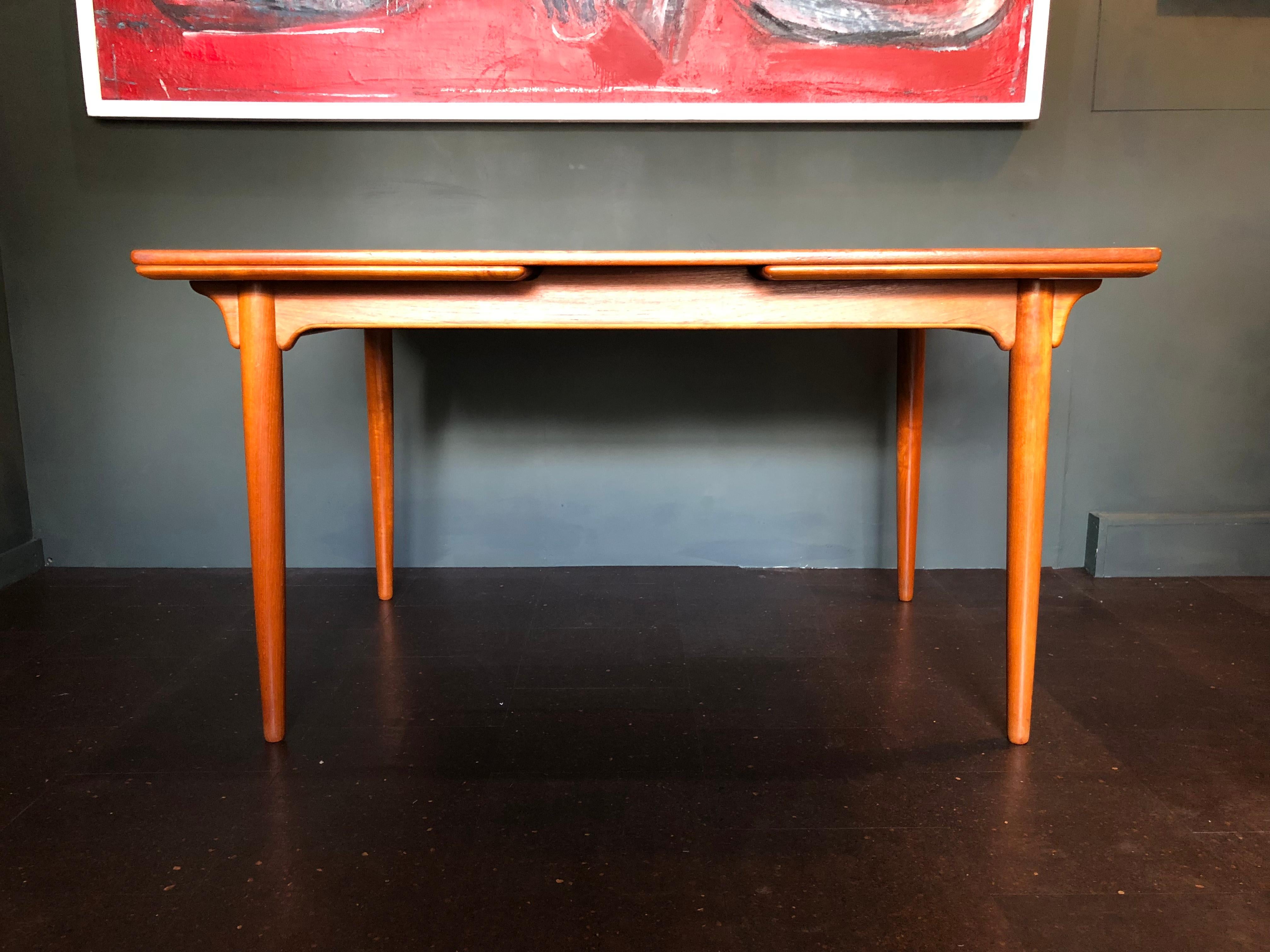 Classic Omann Jun - Gunni Omann dining table in Teak. Double extending. Produced in Denmark circa 1960. In fantastic condition with surface repolishing. Dismantles and assembles easily for safer shipping/transport. Extends to 238cm.
