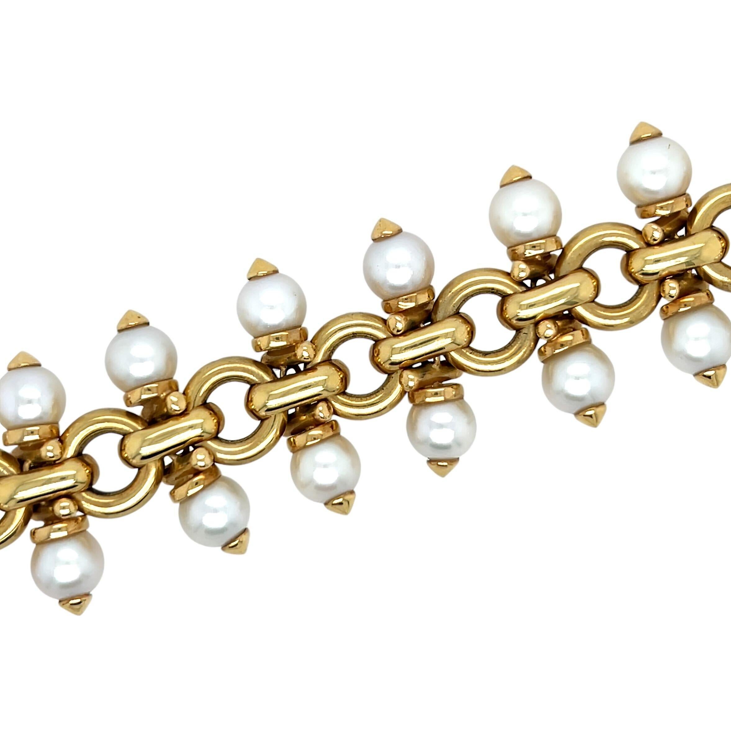 An 18 karat yellow gold and pearl bracelet, Omar Torres.  Fashioned as bracelet of alternating circle and bar links, each bar link intersected by a bracket suspending a pearl on either side of the bracelet, the 24 pearls, ranging in size from