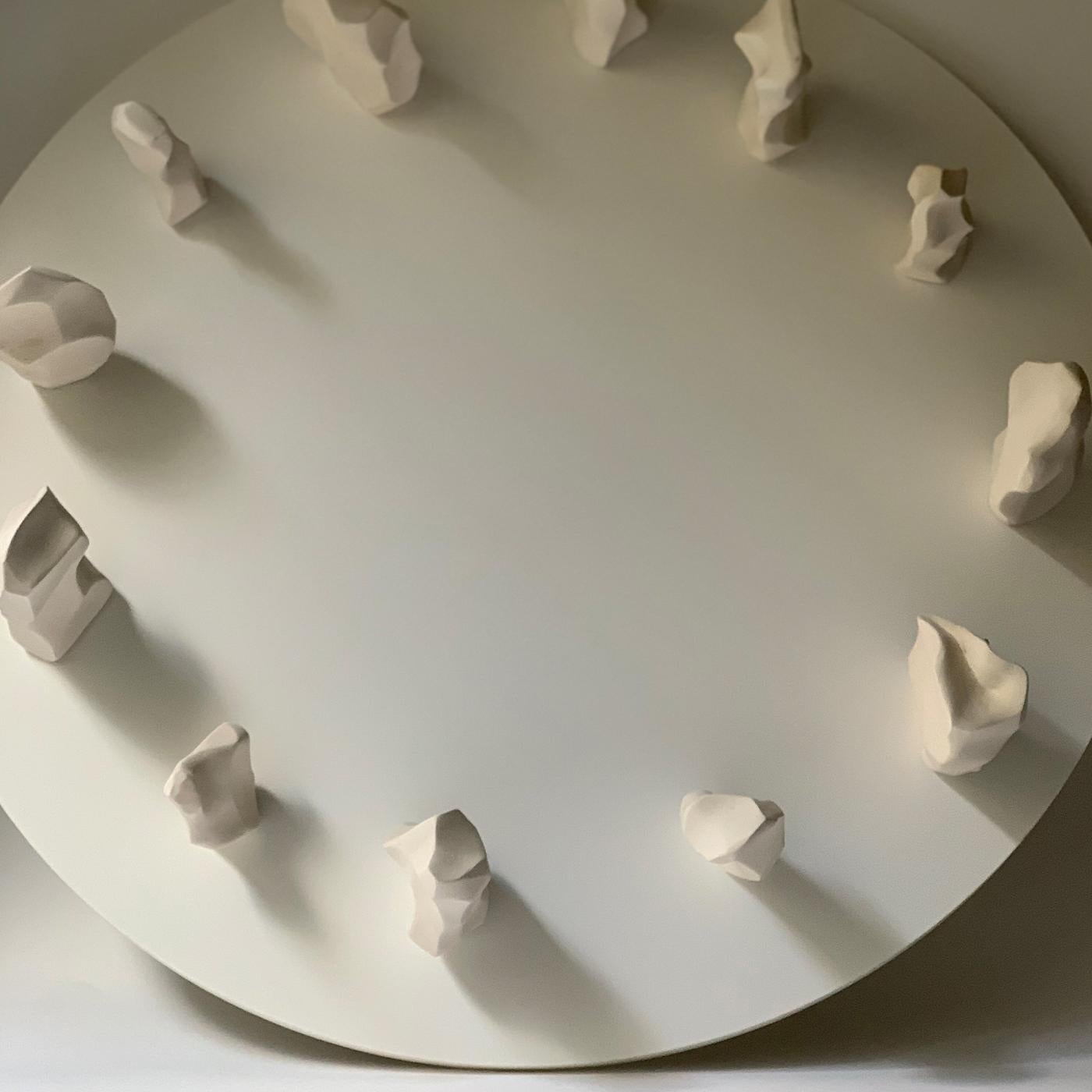 Inspired by the division of time and recalling a round wall clock, this sculpture will be ideally displayed under a natural light source that will create different shadows based on the time of the day. An embodiment of the continuous change of