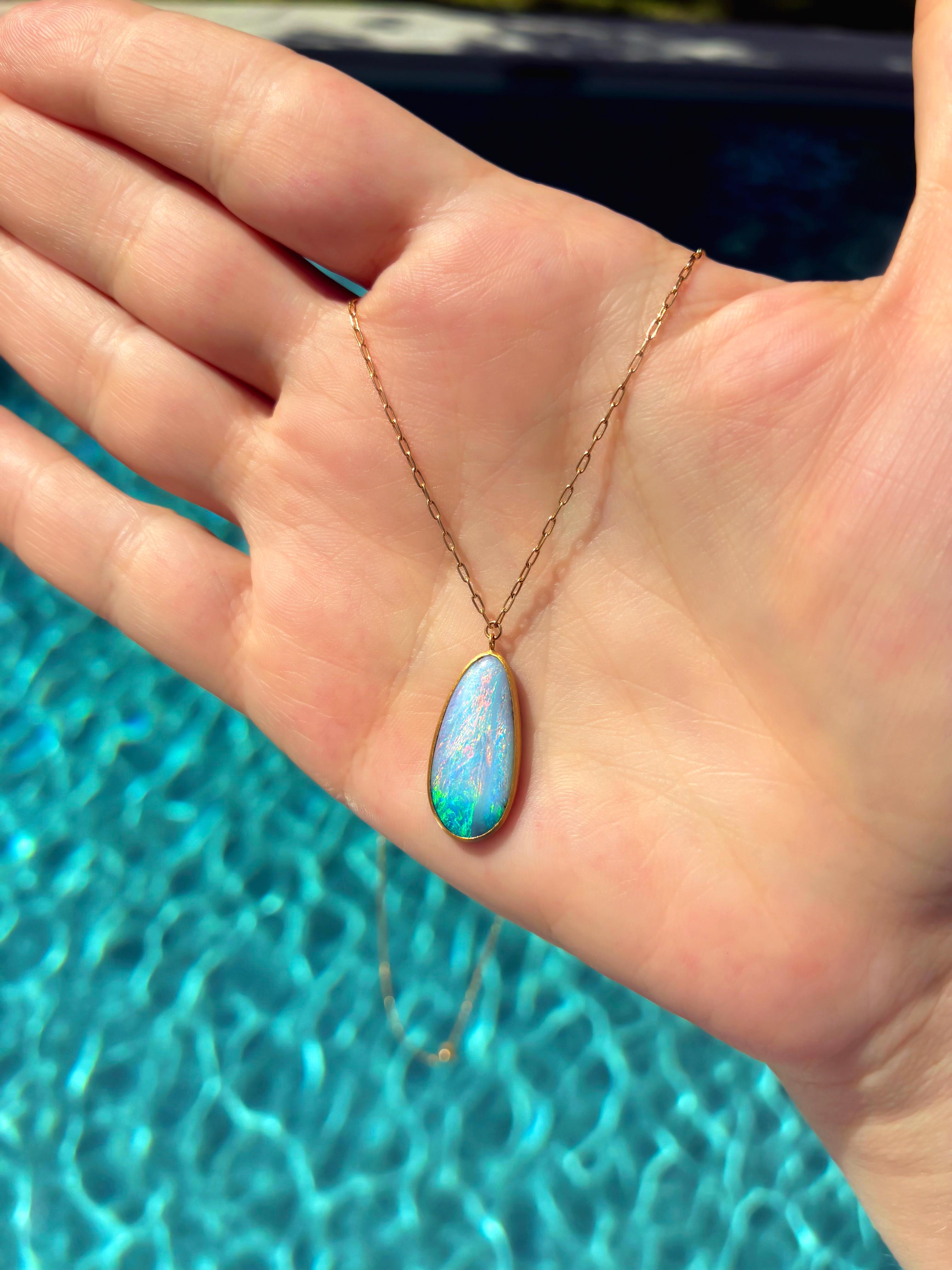 This exquisite boulder opal necklace is a true collector’s piece from Japanese jewelry artist Shinobu Marotta of Talkative Atelier. The pendant showcases a rare 4.74 carat Australian boulder opal, prized for its extraordinary play-of-color. Shades