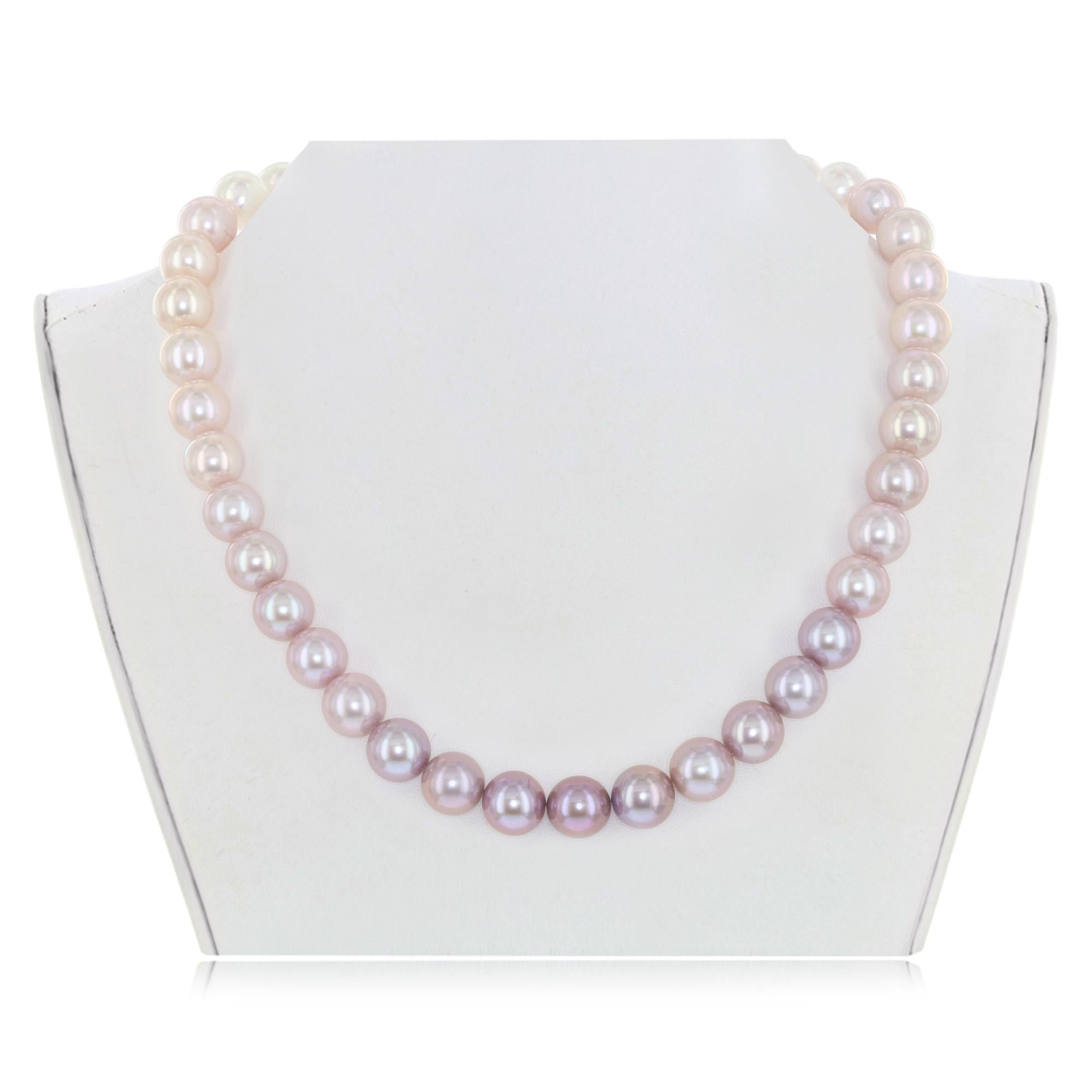 This exquisite ombre Chinese freshwater cultured round pearl necklace graduates from white at the ends to natural color pink in the center. The distinctive, lustrous pearls measure 10-11mm. This necklace features an elegant 14K white gold