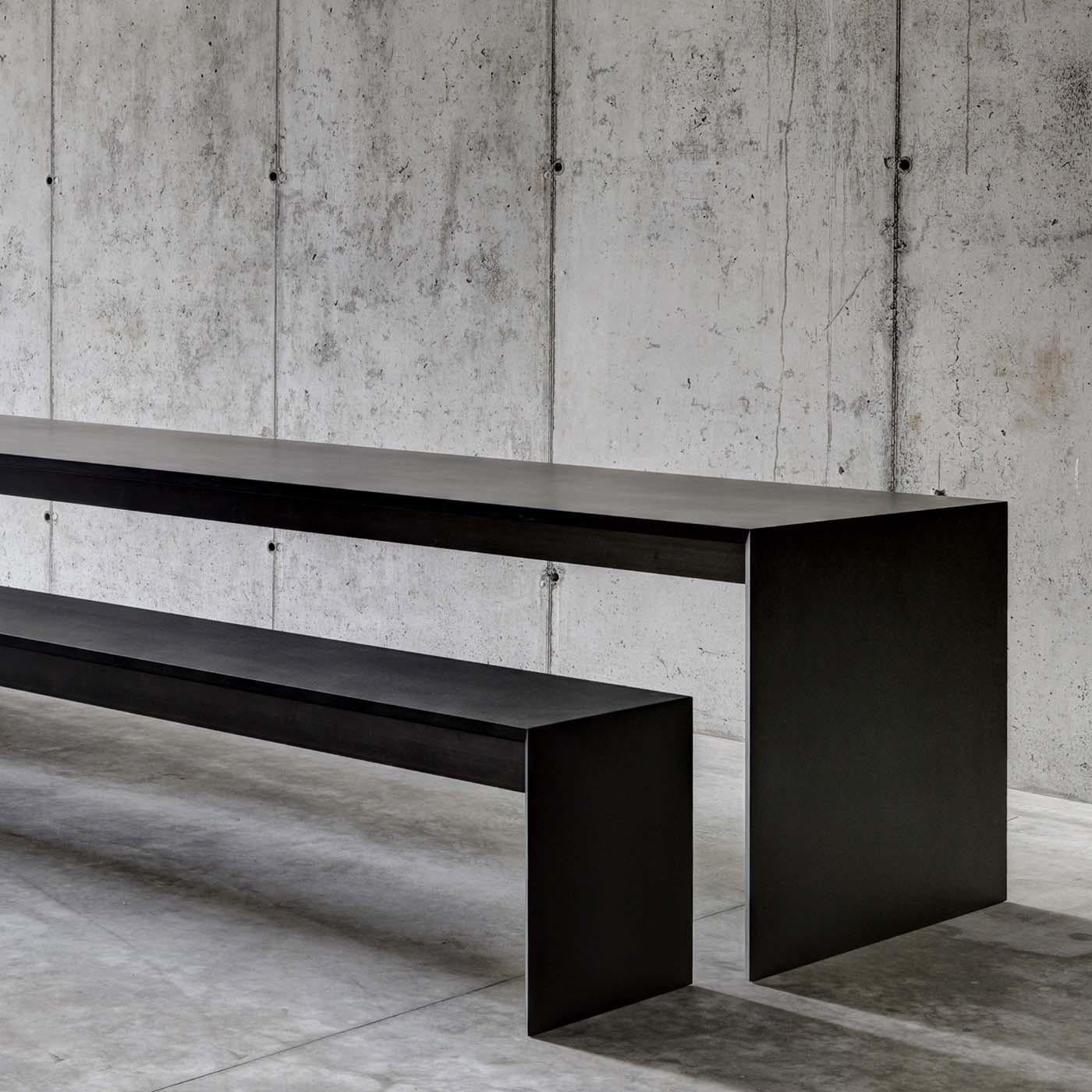 This stunning bench is designed by Studio Guscetti and will ideally complement the Ombrì 01 Table by Studio Guscetti. Its structure in Medium Density Fiberboard has the same black pastel matte finish as the table with 45-degree joints to add