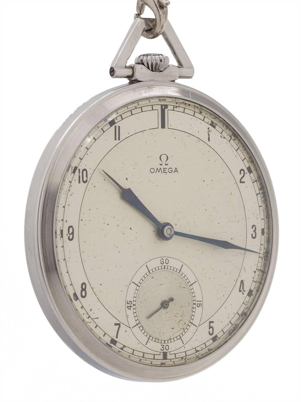 
Vitnage Omega Art Deco era man’s pocket watch circa 1935. Featuring a 45mm diameter 12 size (12-S)  open face industrial design stainless steel case with trapezoidal shaped bow, and a great looking original 2 tone silvered satin dial with printed