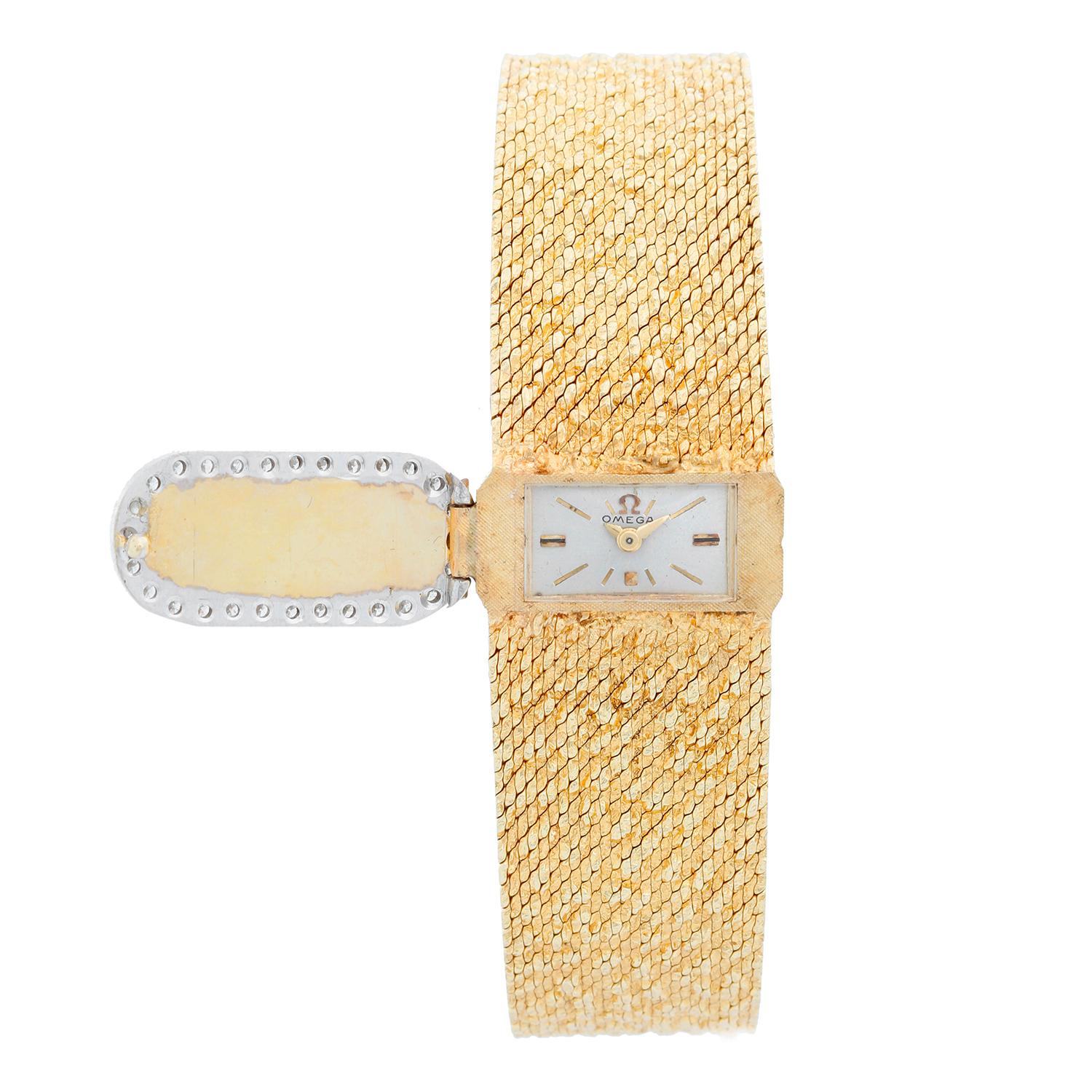 Omega 14K Yellow Gold Vintage Ladies Watch - Manual. 14K Yellow gold ( 11 x 20 mm) with diamond and yellow gold cover. Silver dial with raised gold hour markers. Textured 14K Yellow gold Bracelet. Will fit a 6 3.4 inch wrist . Pre-owned with custom