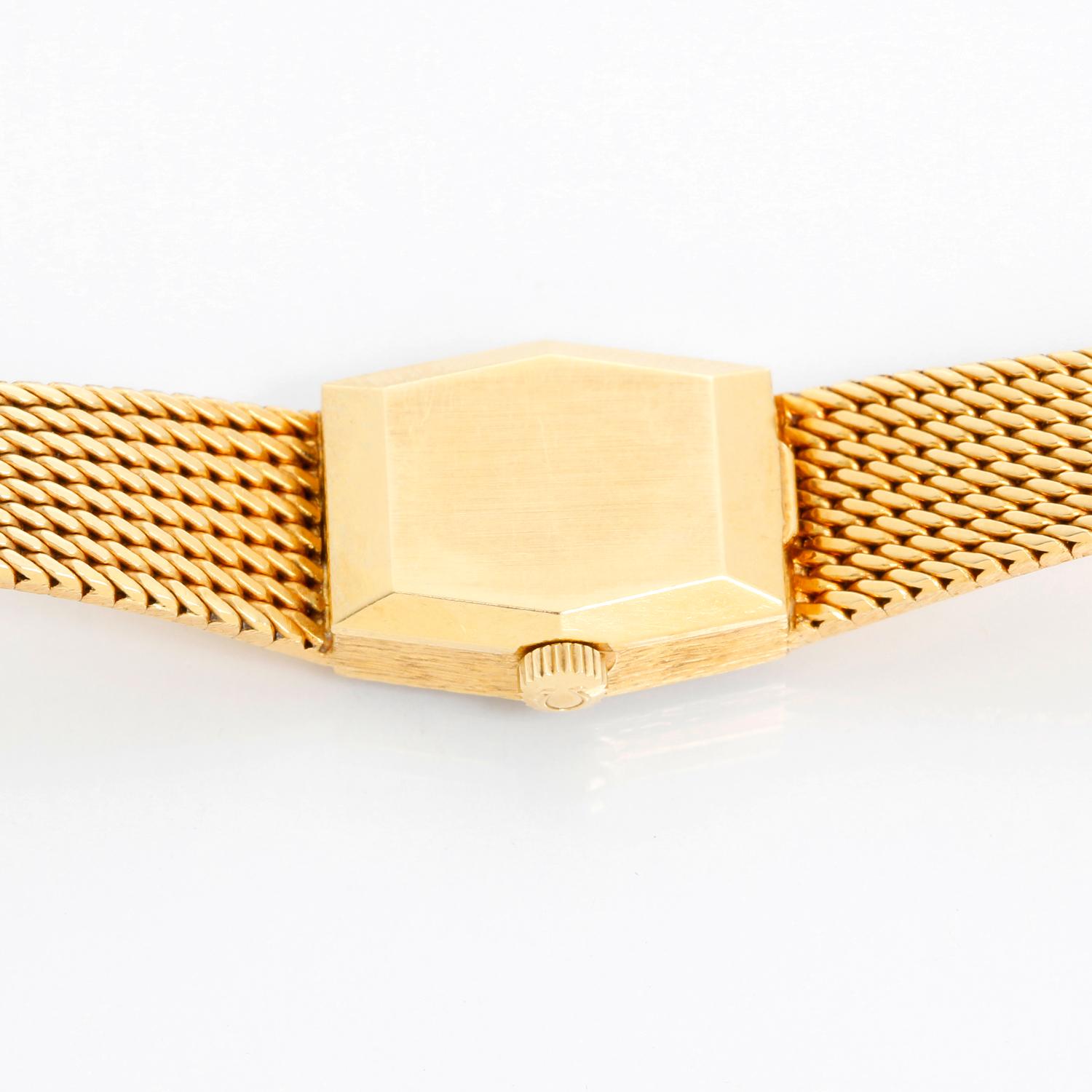Omega 18K Yellow Gold Classic Watch  Ref 8261 - Manual winding . 18K Yellow gold ( 21 x 16 mm) . Champagne textured dial with stick hour markers . 18K Yellow gold mesh bracelet; will fit a 6 inch wrist or smaller . Pre-owned with custom box .