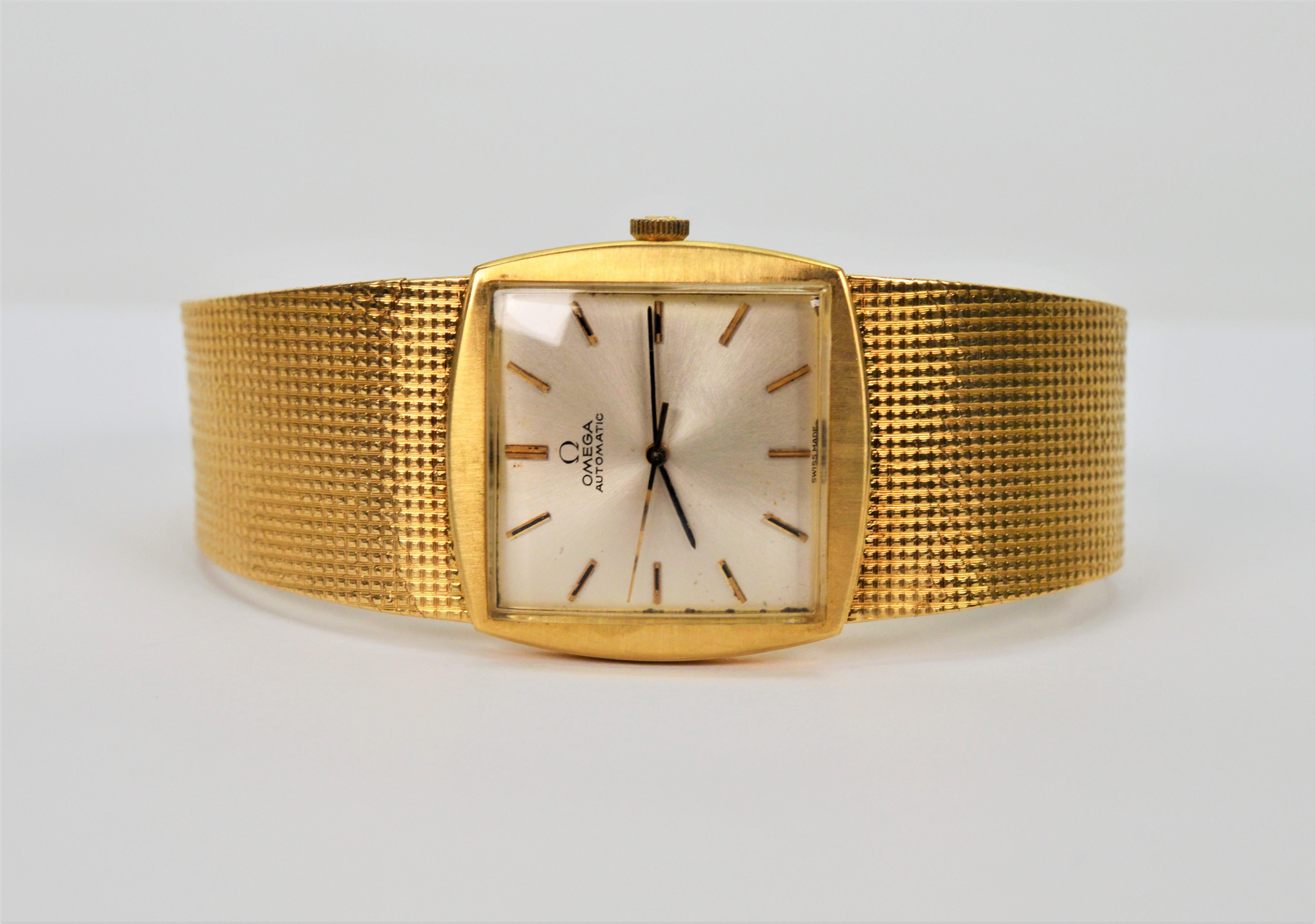 Bold, all in 18 Karat Yellow Gold, this sleek Omega Men's Dress Wrist Watch evokes the revered elegance and style of its era. Circa mid 1960's, this retro Omega beauty has an Swiss automatic movement #23162809. The satin polished gold square case