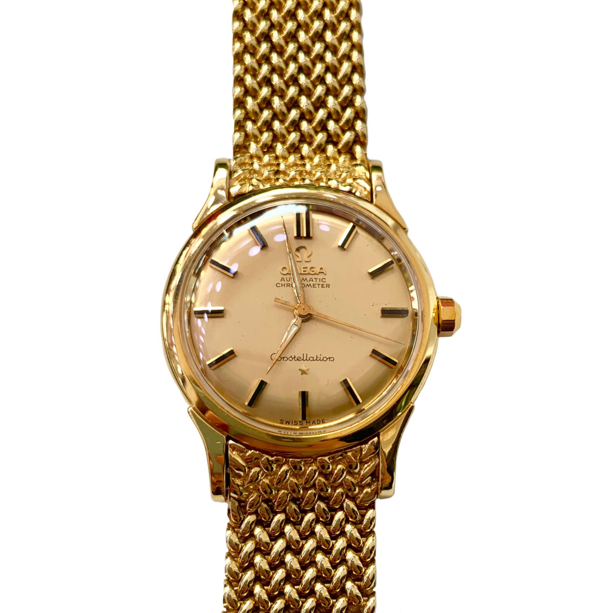 Men's very heavy 18K yellow gold Omega Constellation automatic chronometer watch circa 1960's. It has a very flexible permanent mesh bracelet, movement #505, case #2852-2853 and serial numbers 11462243. The entire piece weighs 127 grams! The