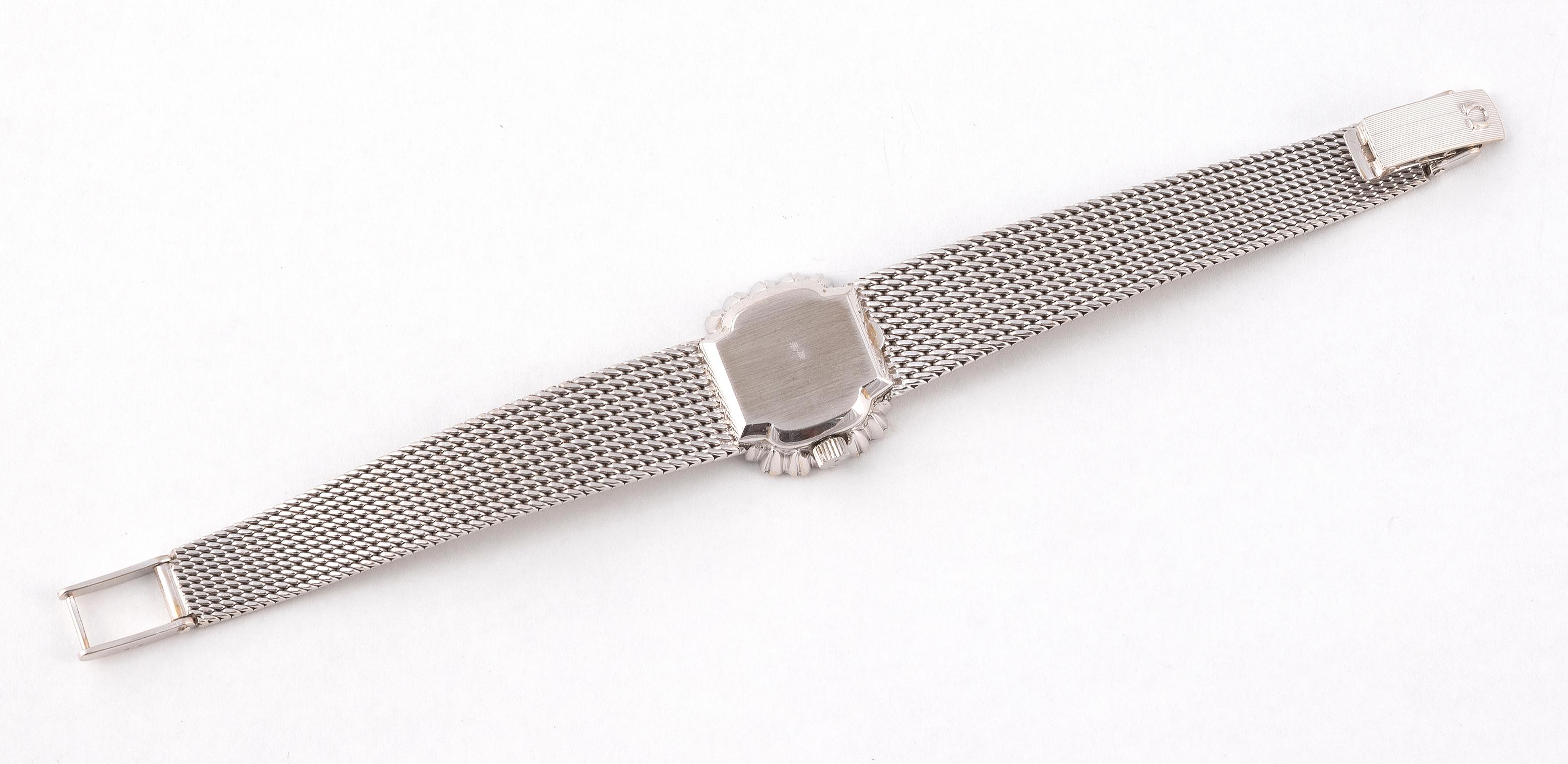 Lady's watch in 18K white gold, bezel set with diamonds, cushion dial with signed anthracite lacquered background, four applied stick indexes, mechanical movement with manual winding (caliber 485, signed and numbered 33702870) . Signed and numbered