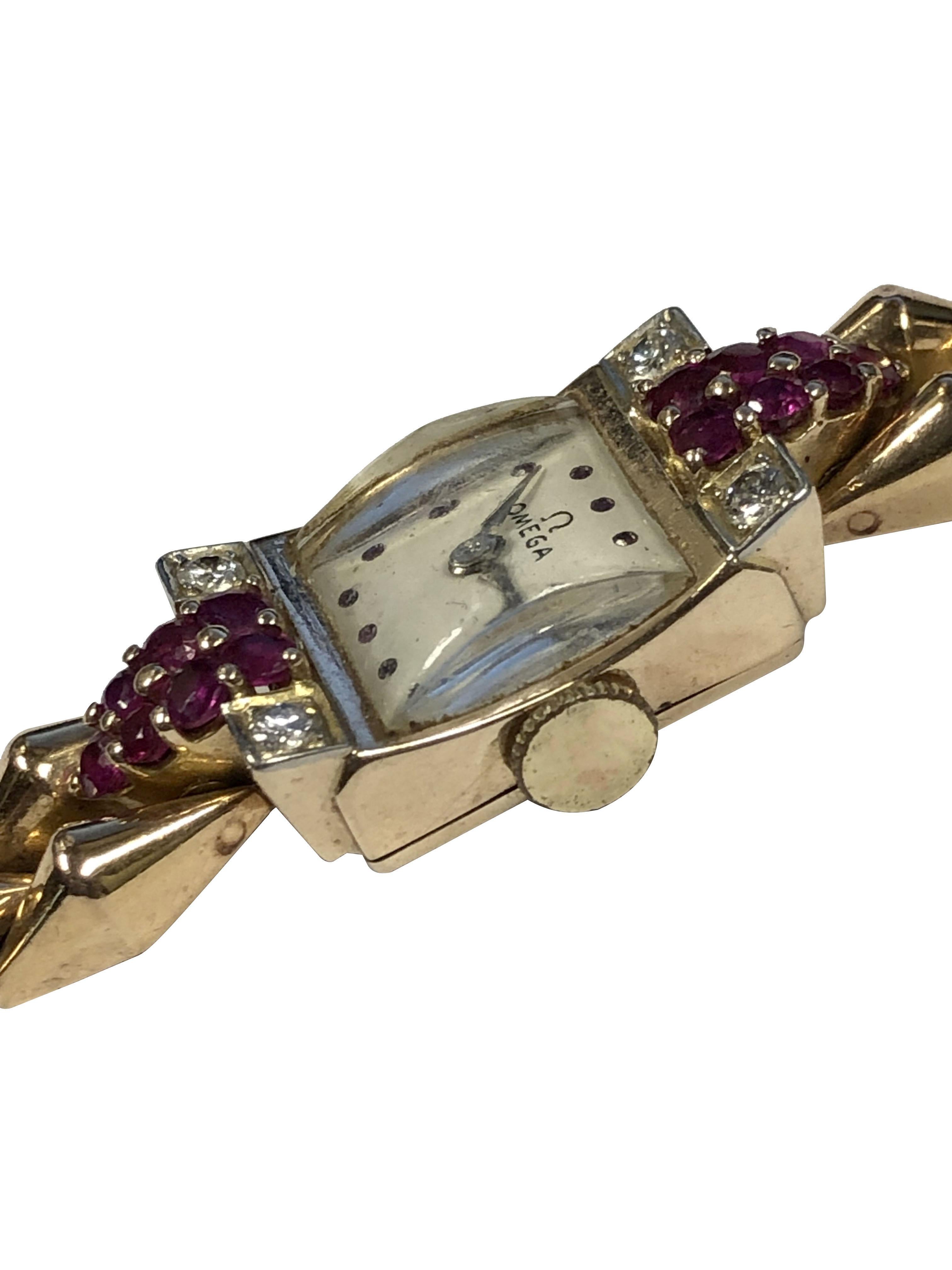 Circa 1940s Omega Ladies Bracelet Watch, 22 x 14 M.M. 14k Rose Gold Signed Omega 2 piece case, the case top is set with Fine color Rubies and Round Brilliant cut Diamonds. 17 Jewel Mechanical, Manual wind movement, White Dial with Ruby set markers.