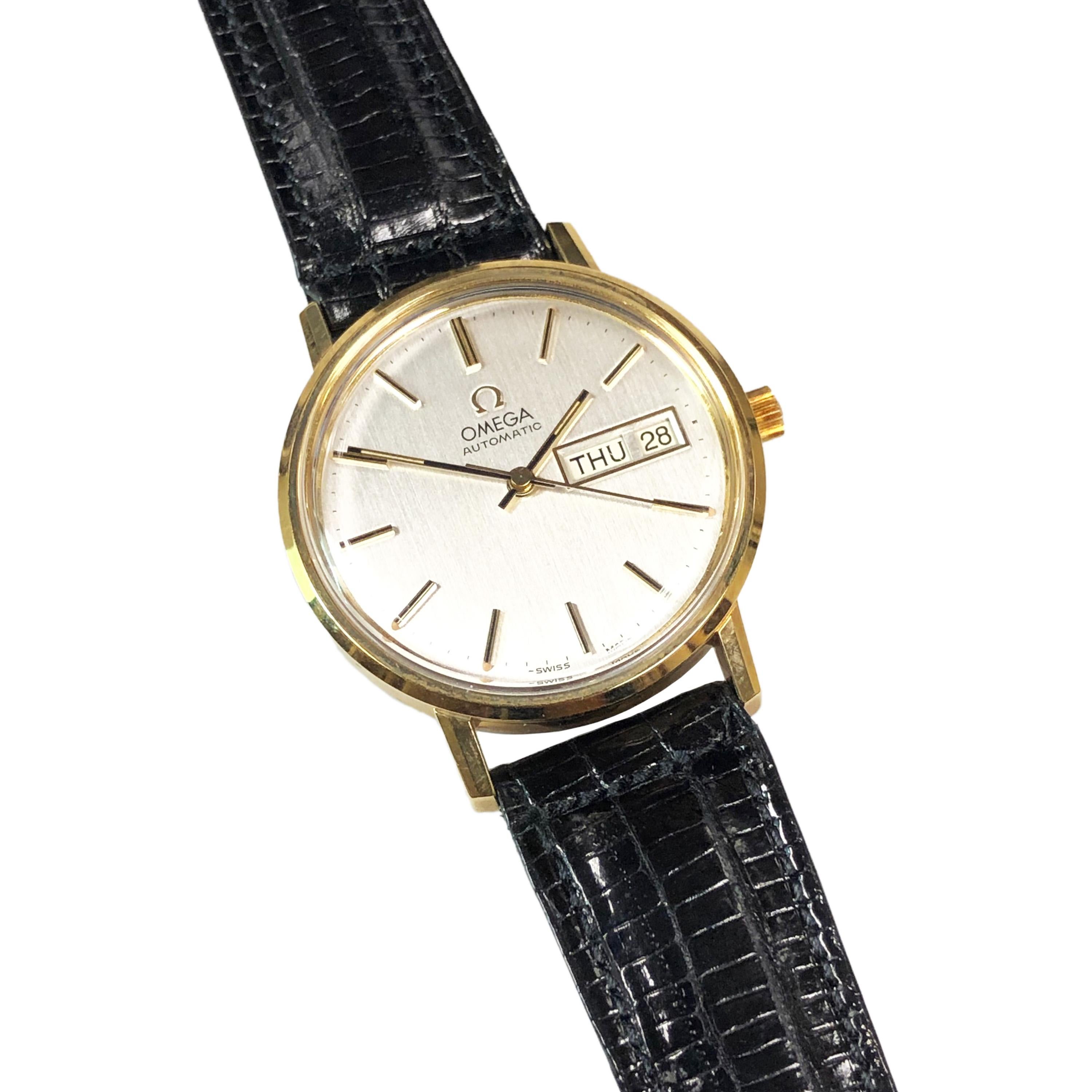 Circa 1960s Omega Gents Wrist Watch, from a recent discovery in a Jewelry store safe, never worn, new old stock, 35 MM Gold  Shell top with Stainless Steel Back 2 Piece case.  Caliber 1020 Automatic, Self Winding movement. Silver Dial with raised