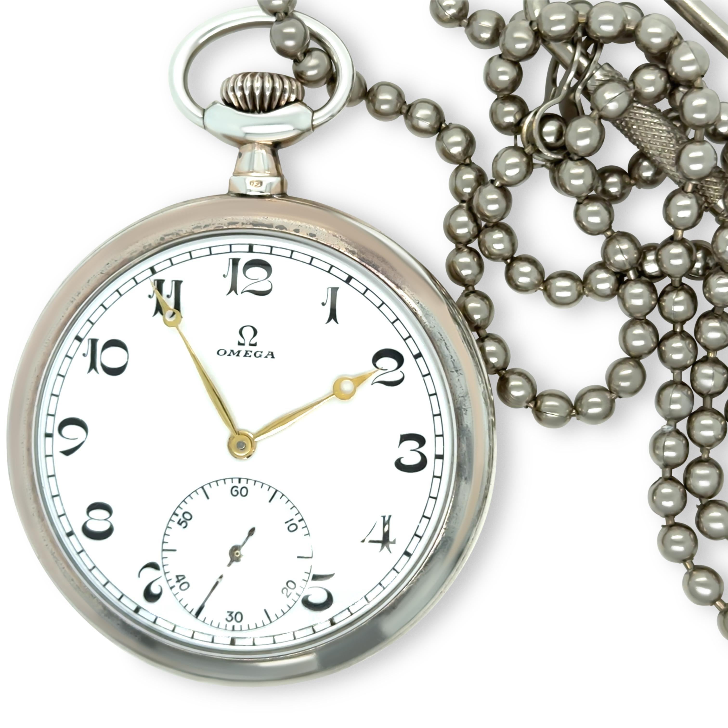 This Omega pocket watch, dating back to circa 1915, is a beautifully preserved timepiece crafted in 800 silver with a 50mm case. The watch features a white dial with black Arabic numerals, complemented by golden Breguet-style hands and a subsidiary