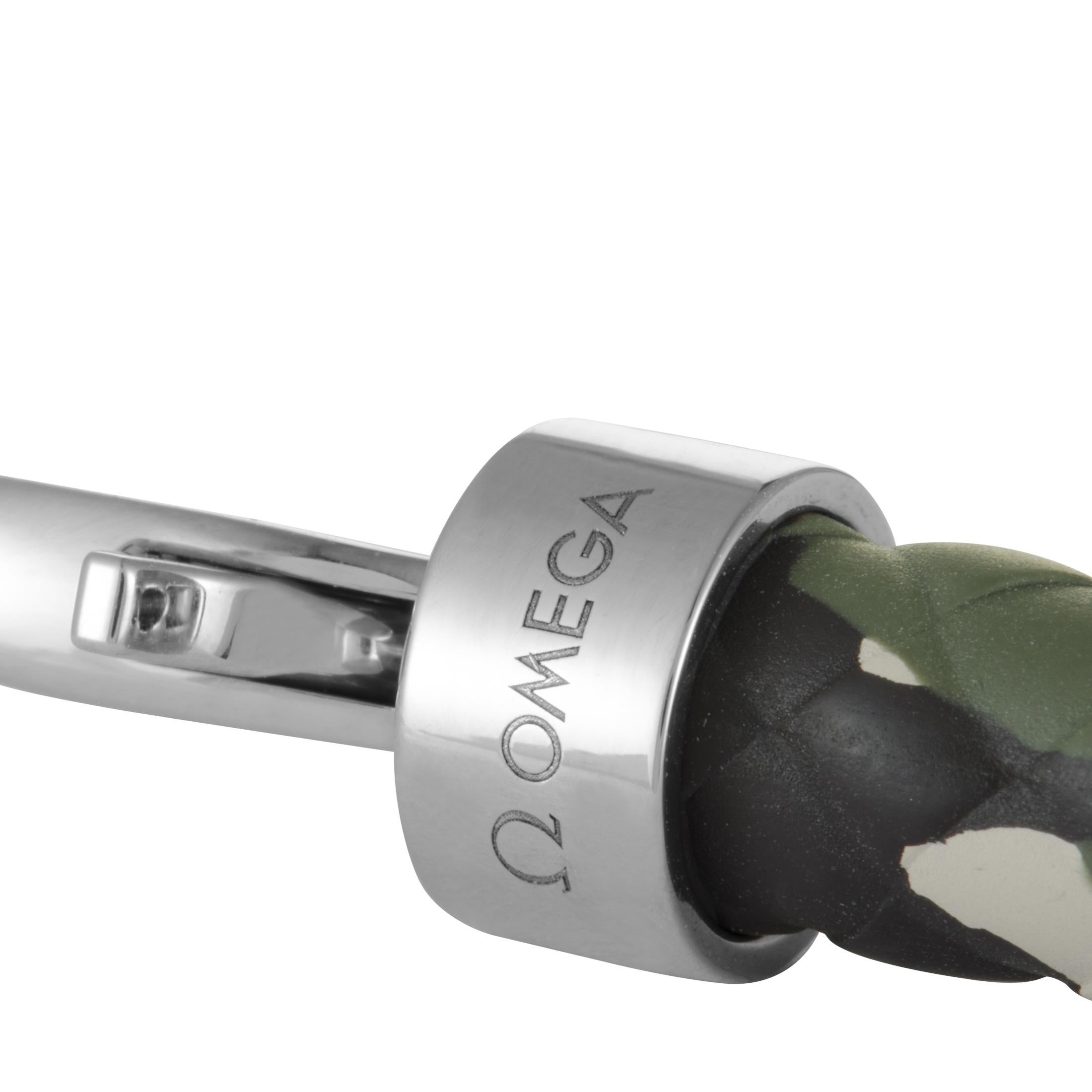 The Omega “Aqua Sailing” bracelet is made out of stainless steel and green camo rubber and features lobster claw closure. The bracelet measures 9.00” in length and weighs 28.5 grams.
 
 Offered in brand new condition, this item includes a gift box.