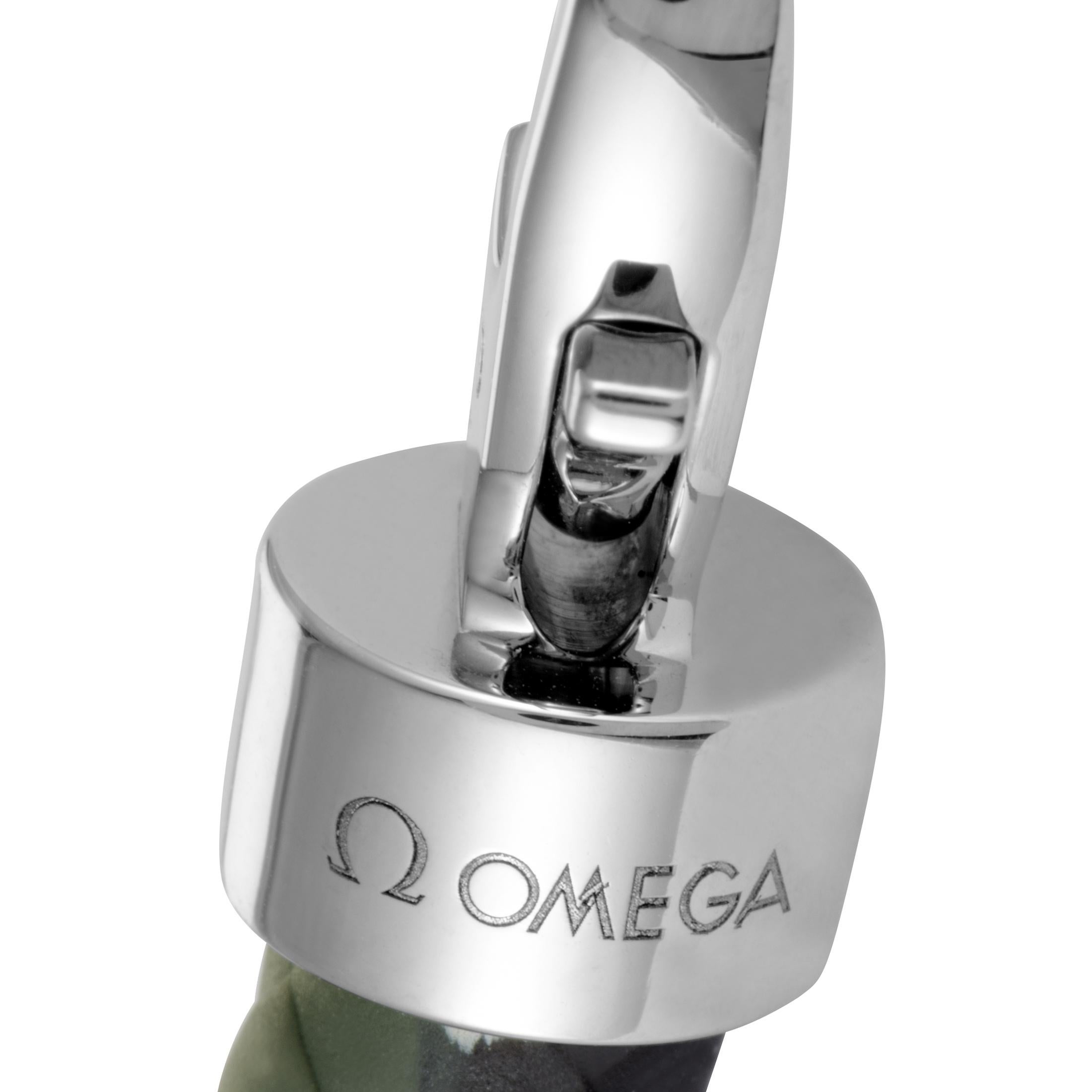 The Omega “Aqua Sailing” bracelet is made out of stainless steel and green camo rubber and features lobster claw closure. The bracelet measures 7.50” in length and weighs 24.7 grams.
 
 Offered in brand new condition, this jewelry piece includes a