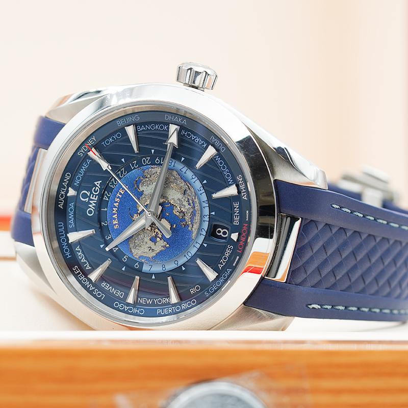 This Omega Seamaster Aqua Terra Worldtimer was recently added to our case and is in very good condition. The Stainless Steel case is 43mm on a blue rubber bracelet. The deep blue dial houses a GMT function as well as a 24-hour day/night dial. The