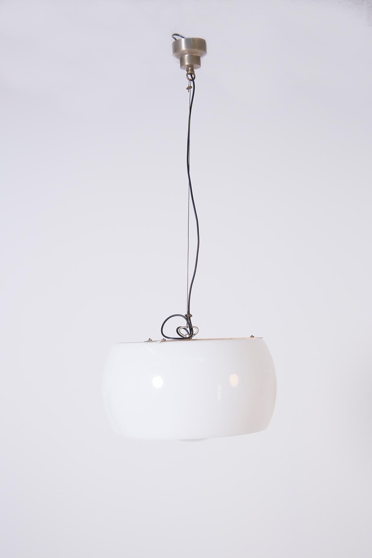 Suspension lamp designed by Vico Magistretti for Artemide, Italy 1962.
The Omega lamp is large in size and consists of two separate pieces of opaline glass on a brushed metal frame. The height of the lamp can be adjusted as required. It mounts an