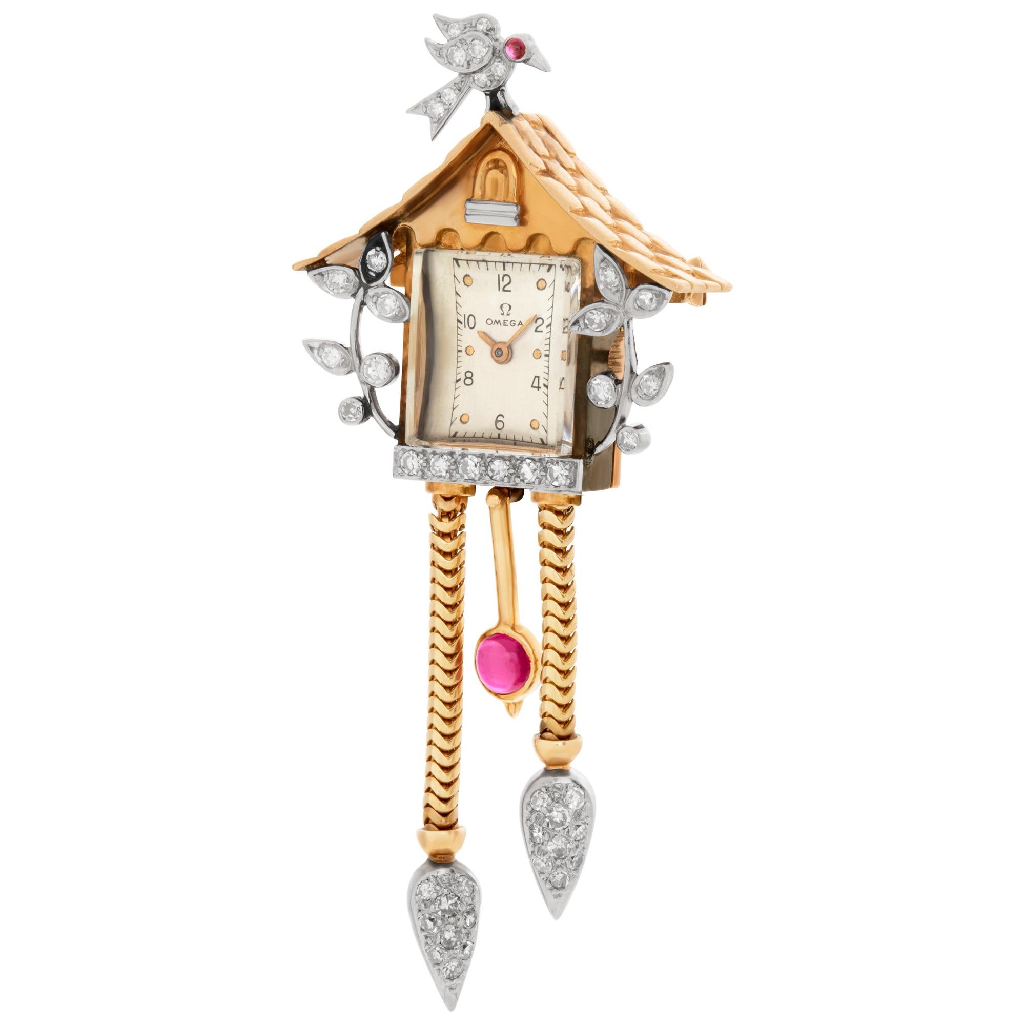 Omega Birdhouse vintage brooch in 14k rose and white gold with ruby and diamond accents.
