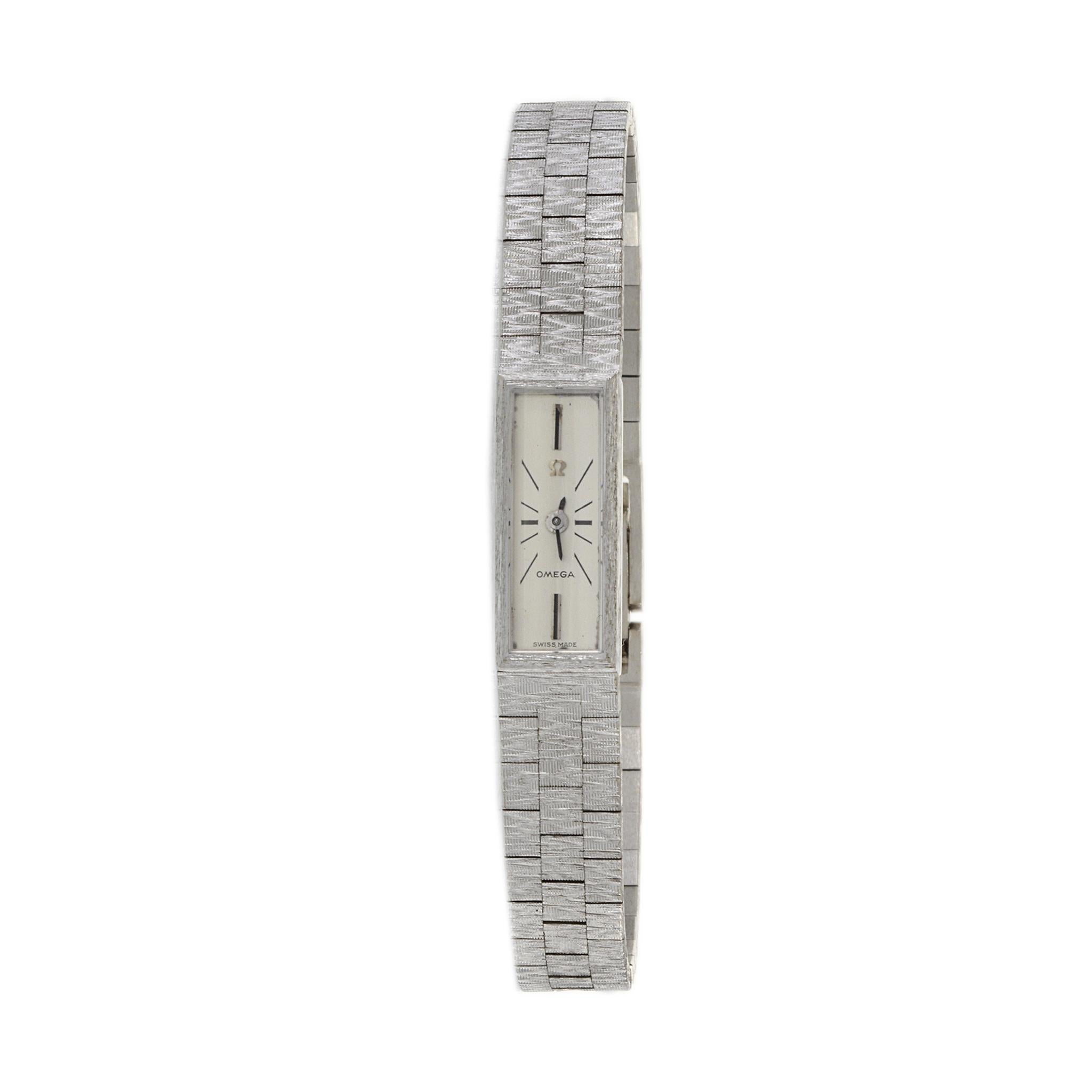 Introducing the Omega 1960s Cocktail Watch, a timeless symbol of elegance and sophistication. Crafted with meticulous attention to detail, this exquisite timepiece features an 18kt white gold rectangular case and matching bracelet, each adorned with