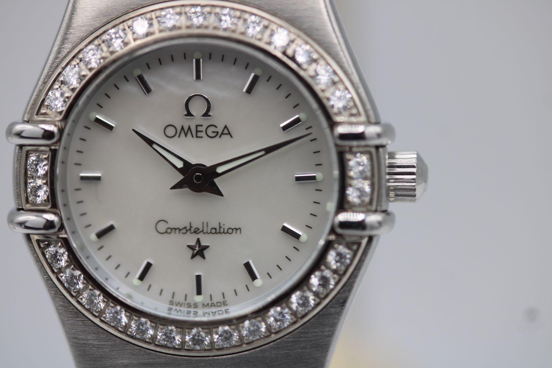 

This Omega Constellation Mini stainless steel wristwatch with diamond bezel dates from 2006 and is in overall excellent condition.
This Omega Constellation 1466.71.00 model features a white mother of pearl dial with silver baton hour markers.  The