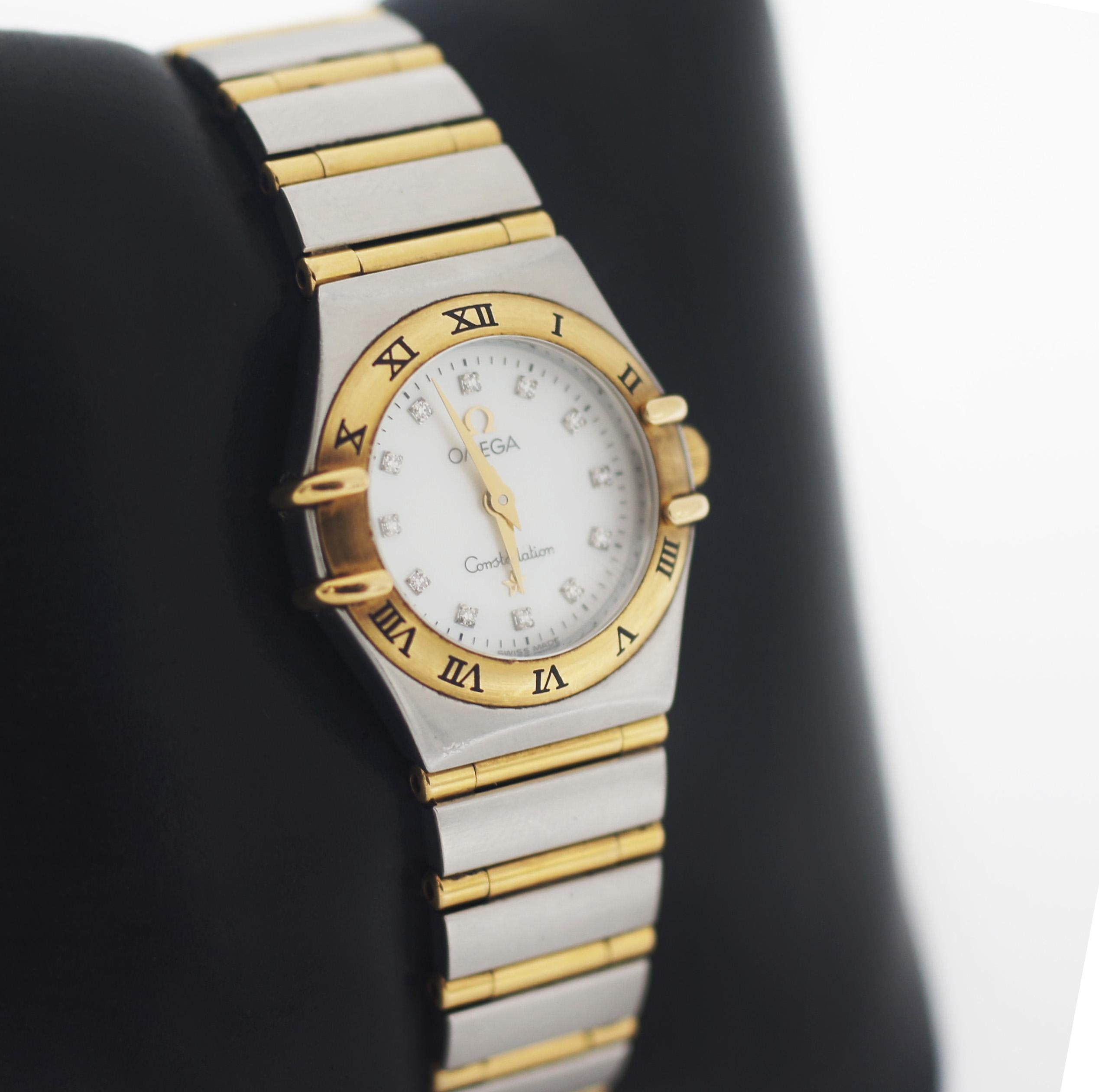 Omega

Constellation

Mother of Pearl Dial 

Diamond hour Markers

Gold sword hour minute hands

stainless steel case

gold bezel with hour roman numerals

Approx. case measures 23mm

Quartz Omega movement
Stainless Steel and Bar gold Bracelet