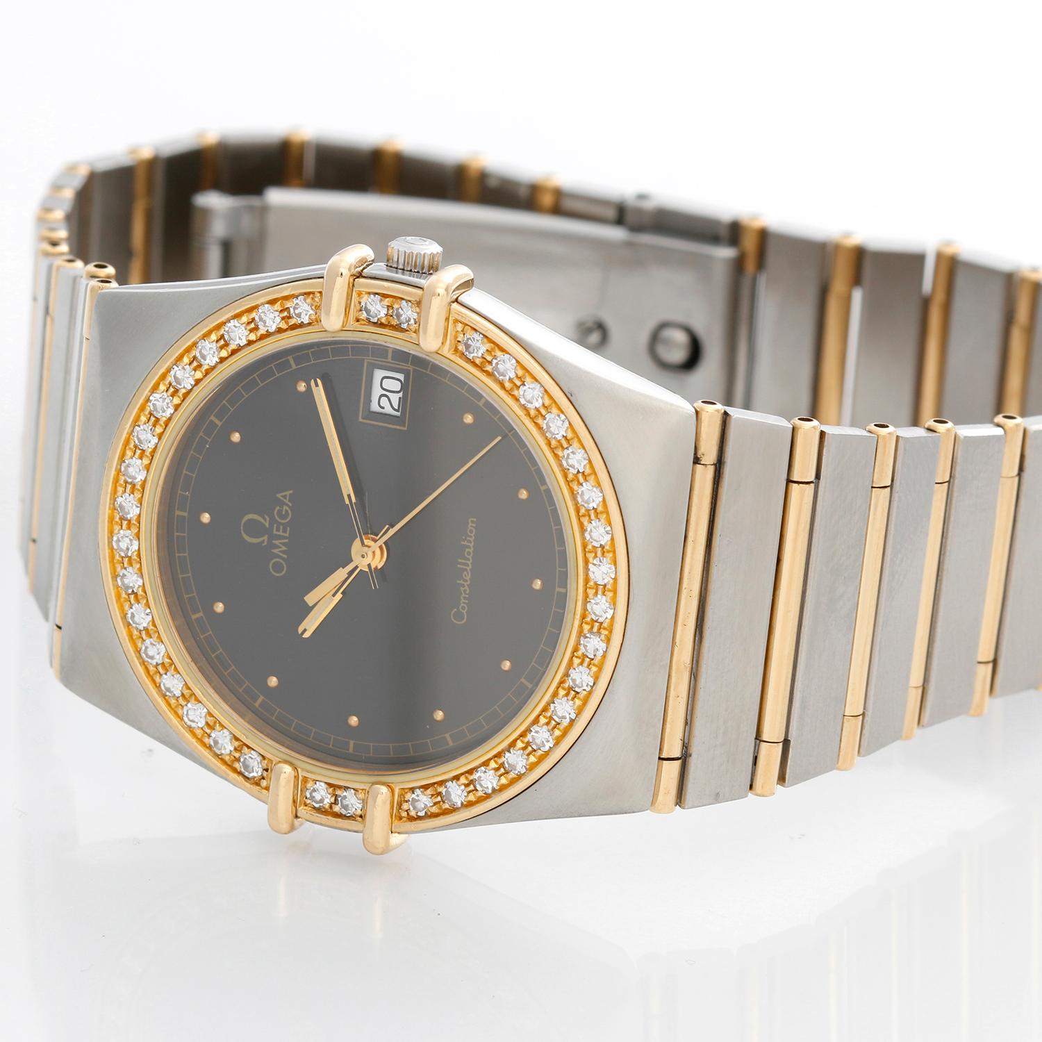 Omega Constellation 2-Tone  Diamond Watch - Quartz. 18K Yellow gold case with a diamond bezel  ( 34 mm ). Black dial with raised stick hour markers. Two tone Omega Constellation bracelet; Will fit up to a 7 3/4 inch wrist . Pre-owned with Omega box
