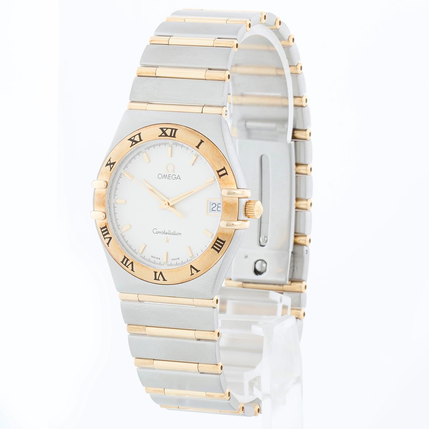 Omega Constellation 2-Toned Men's Watch - Quartz. Stainless steel with 18K yellow gold fixed bezel  (33mm). White dial with luminous hands; date at 3 o'clock. Stainless steel deployment buckle clasp. Pre-owned with custom box.