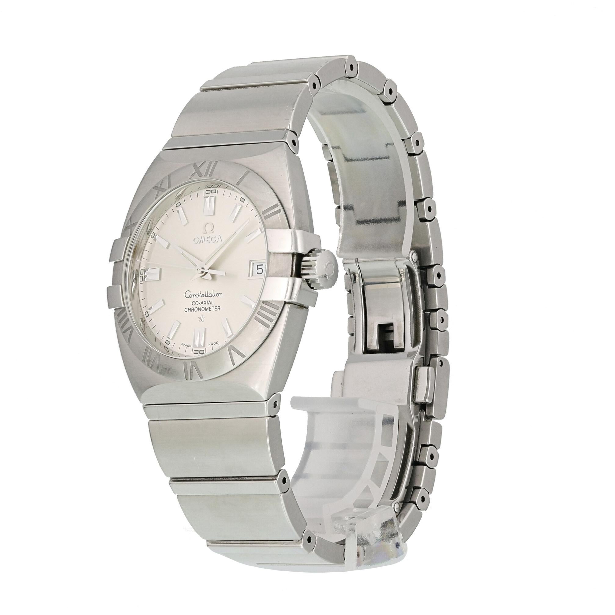 Omega Constellation Double Eagle 1213.30.00 Co-axial Men Watch.
38mm Stainless Steel case. 
Stainless Steel bezel. 
Silver dial with Luminous gold hands and index hour markers. 
Minute markers on the outer dial. 
Date display at the 3 o'clock