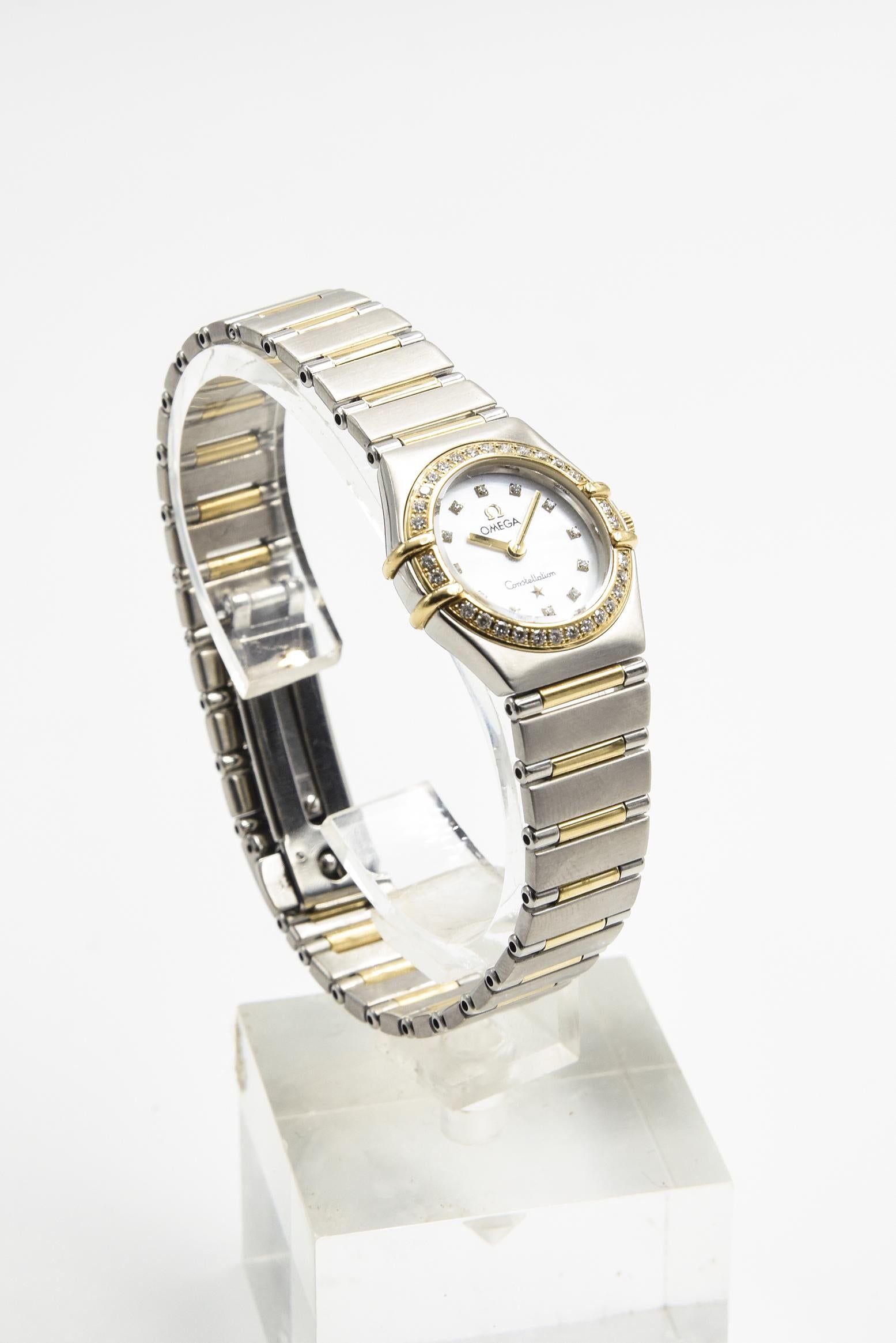 Omega Constellation My Choice Stainless Steel & 18k Gold Diamond Mini Watch 
The watch contains a quartz movement with a white mother of pearl dial and 12 diamond hour markers.  It has a new sapphire crystal.  Around the dial is an 18k yellow gold