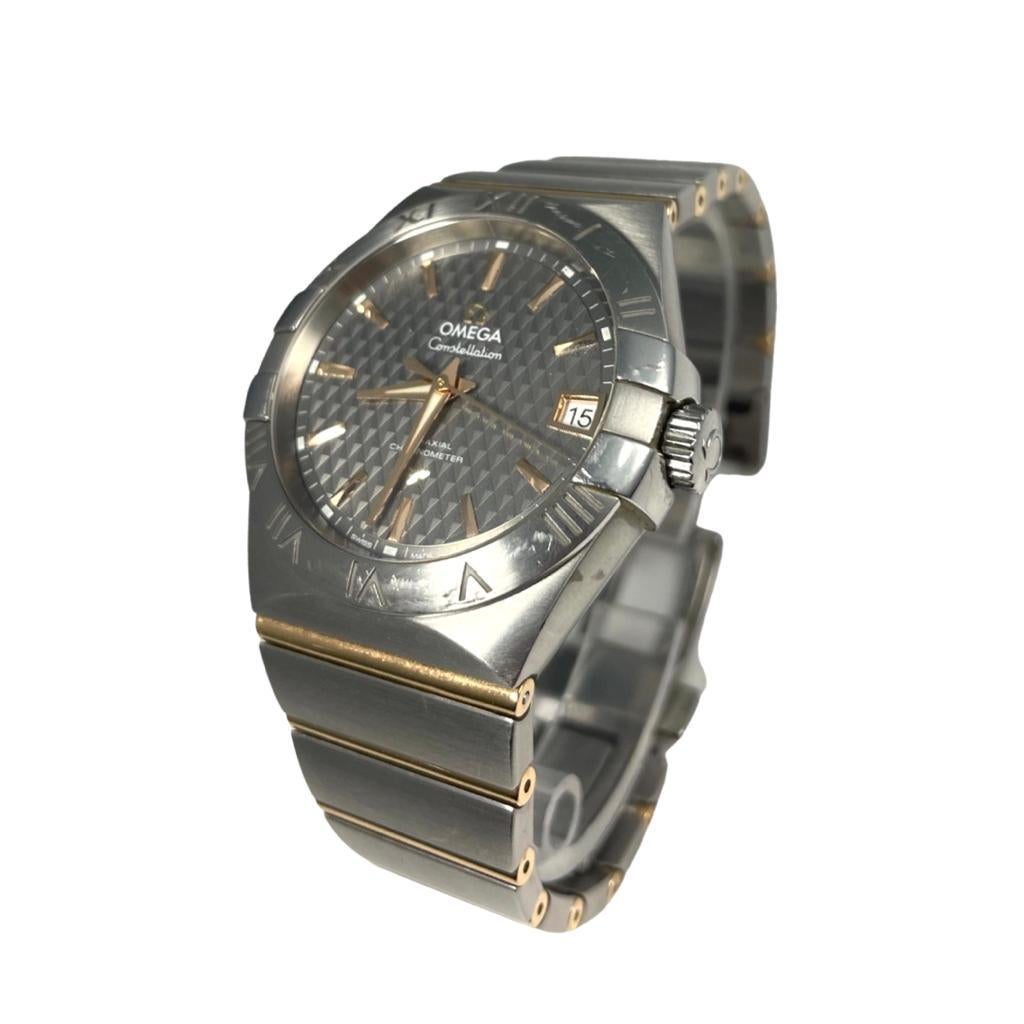 Brand: Omega

Model Name: Constellations

Model Number: 123.10.38.21.06.002

Movement: Automatic

Case Size: 38 mm

Case Back: Open

Case Material: Stainless Steel

Bezel: Stainless Steel

Dial: Gray

Bracelet: Stainless Steel/Gold

Hour Markers: No
